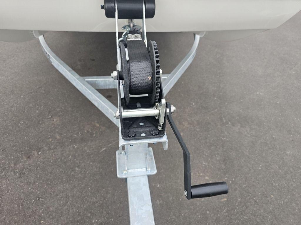 2025 Mako Pro Skiff 15 CC trailer winch on asphalt surface.
