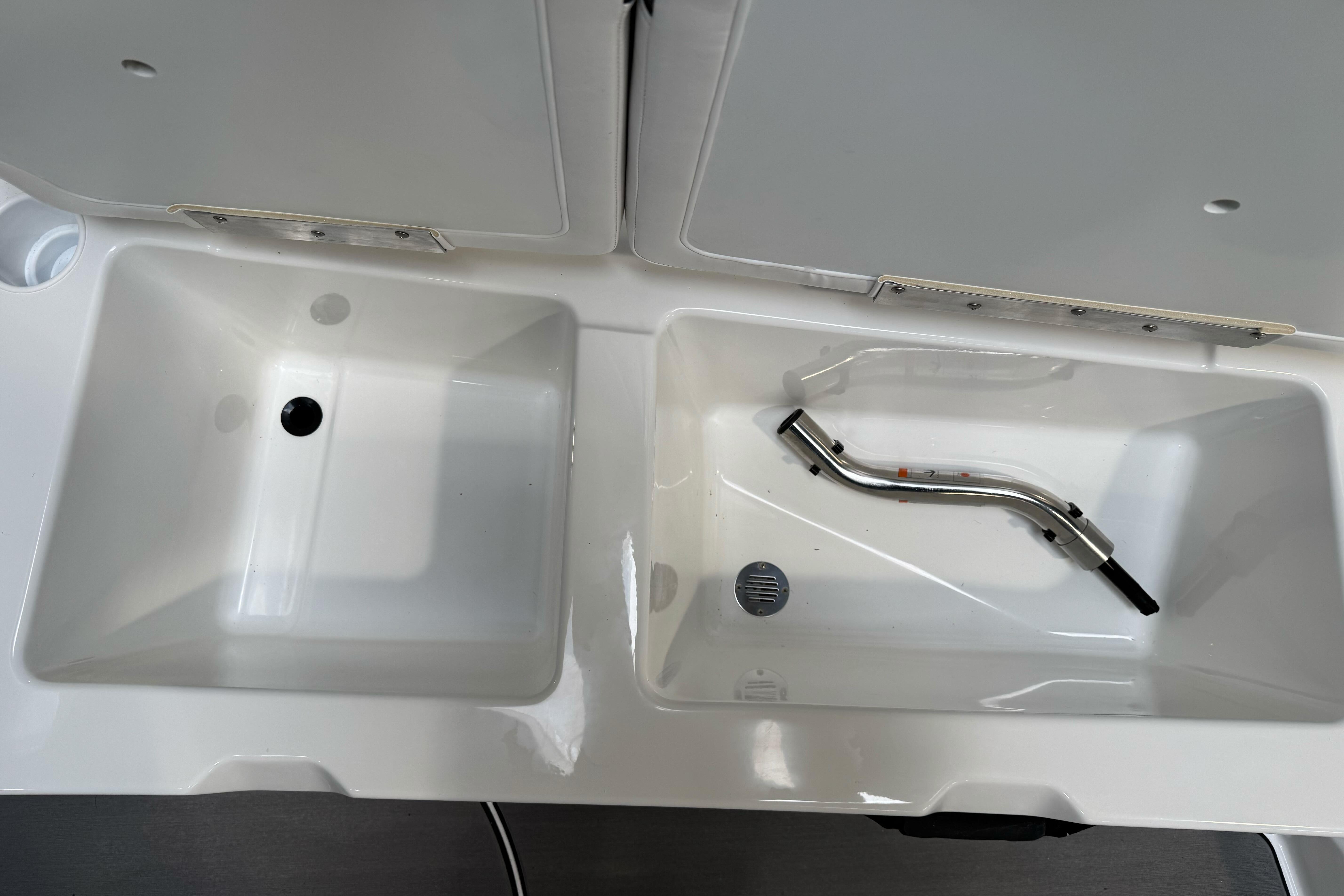 Dual sink setup in a 2026 Tahoe T21 boat, featuring a sleek faucet design.