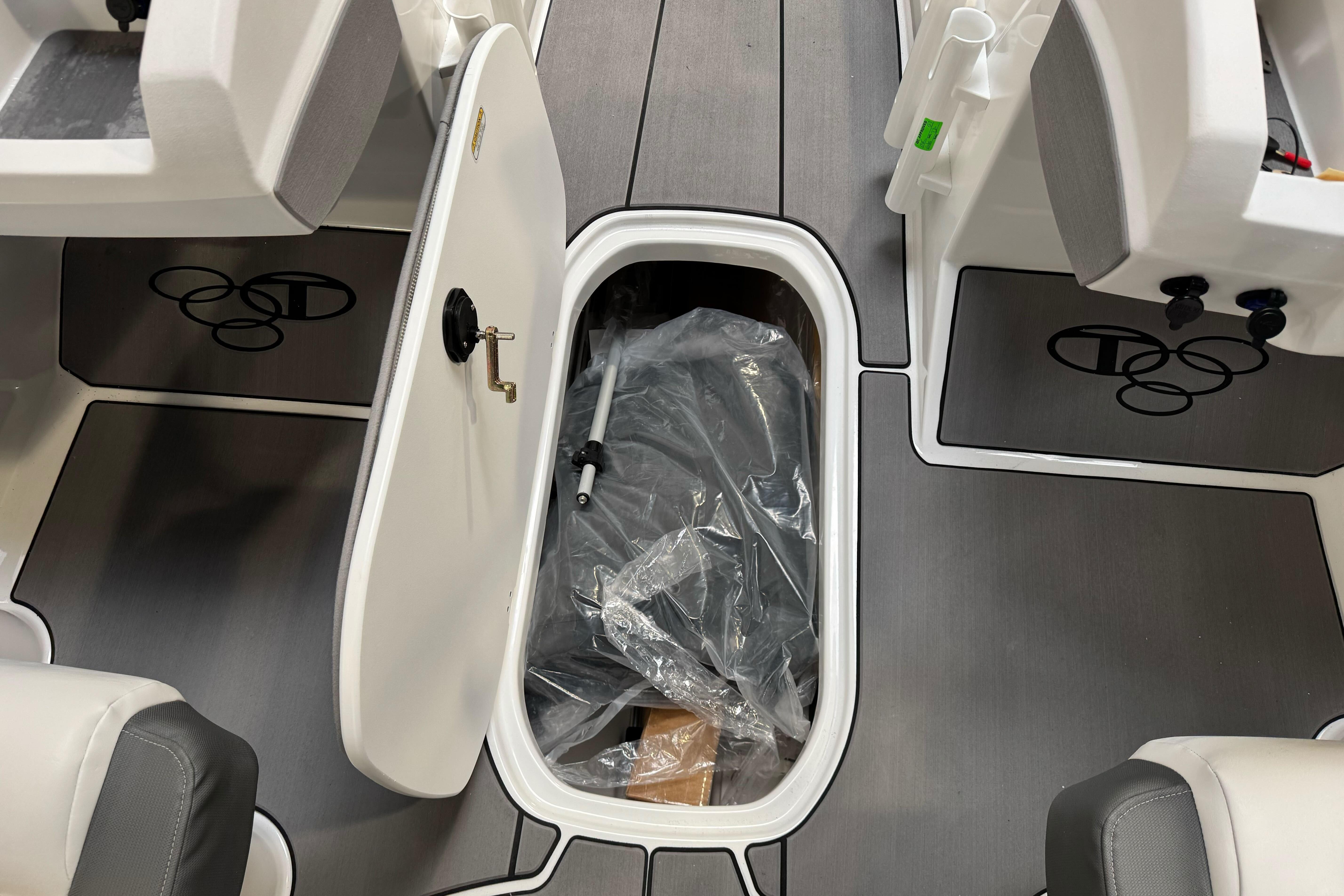 2026 Tahoe T21 boat interior with open storage compartment and sleek seating.