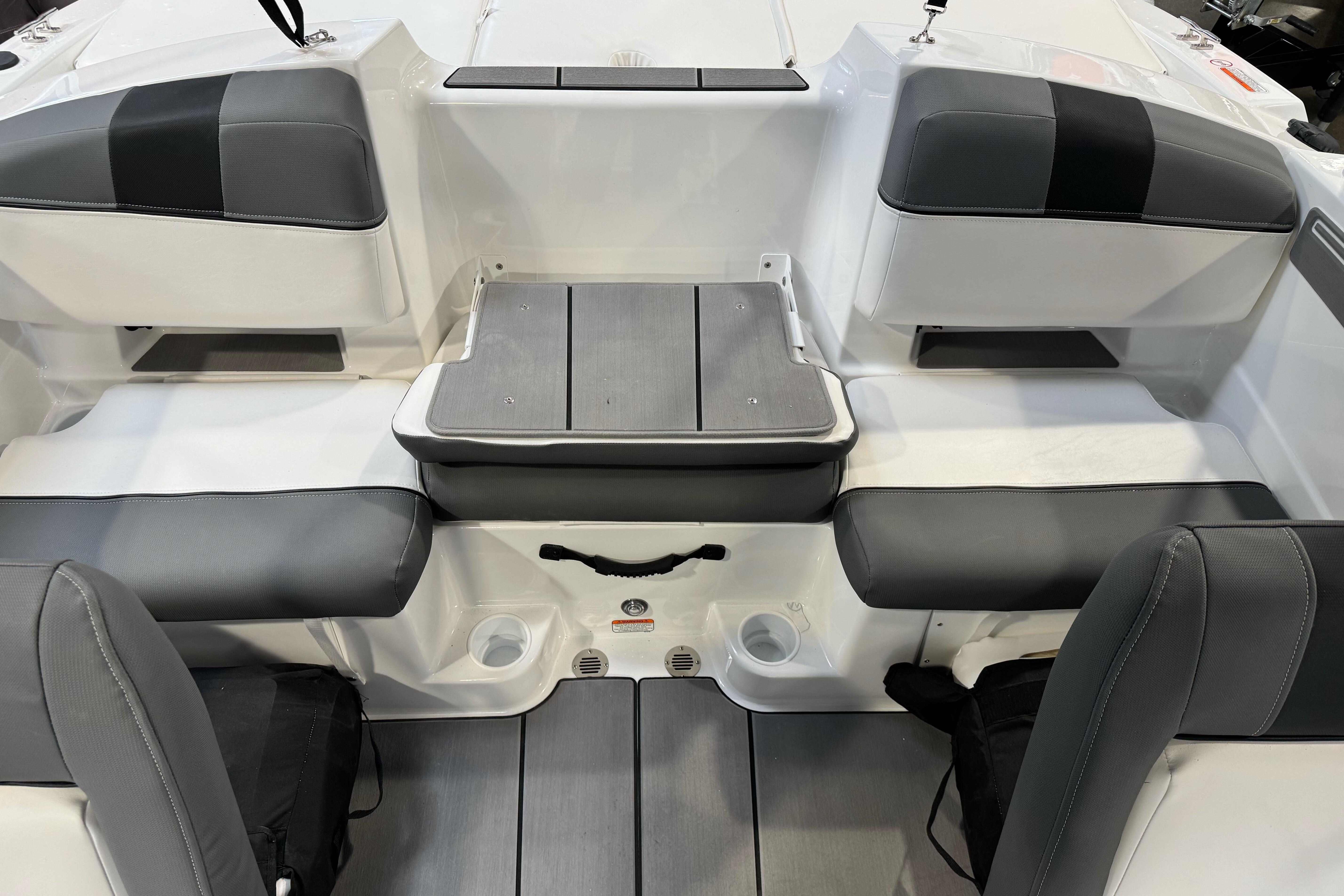 2026 Tahoe T21 boat interior with gray seating and storage compartments.