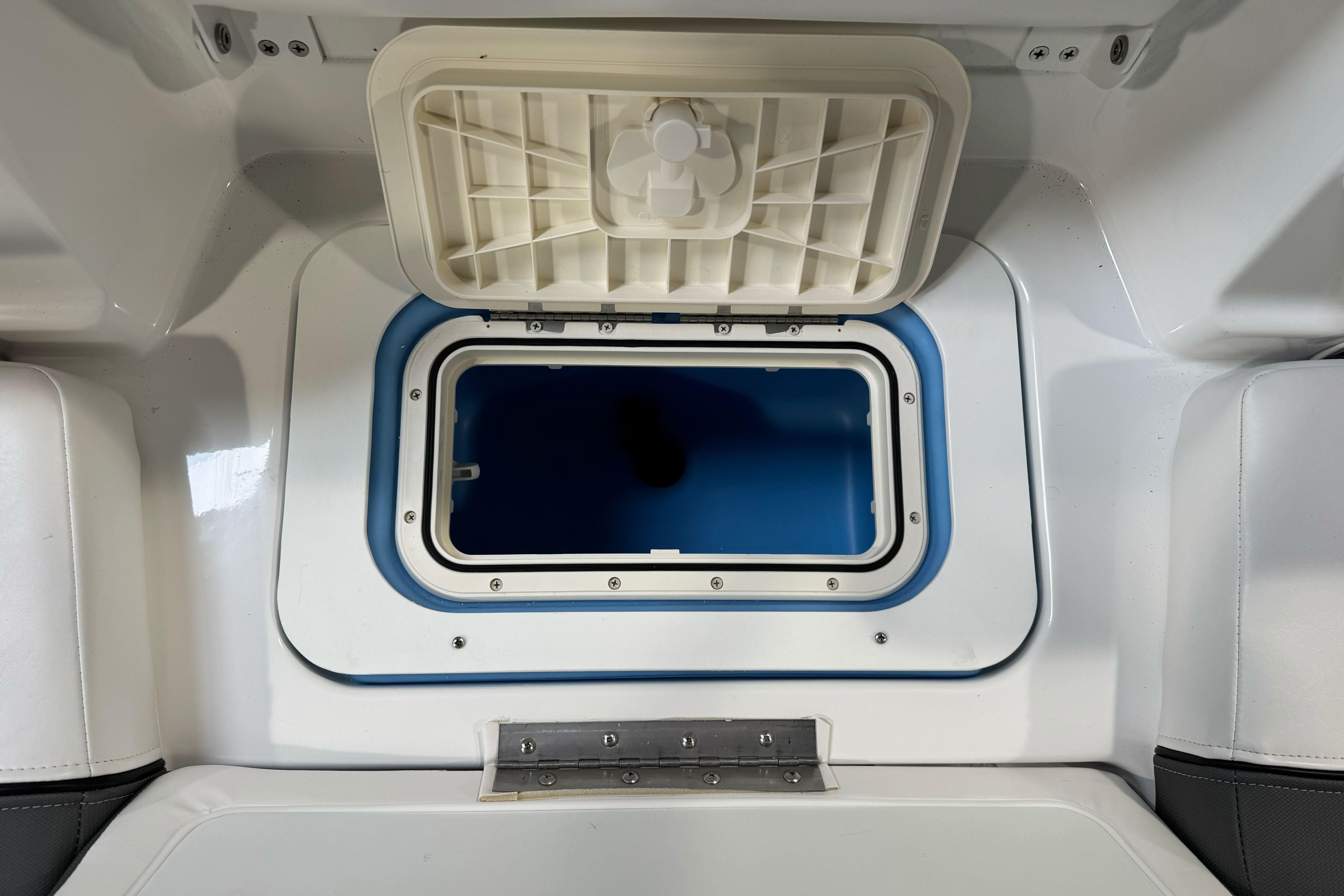 Open storage compartment in 2026 Tahoe T21 boat interior.