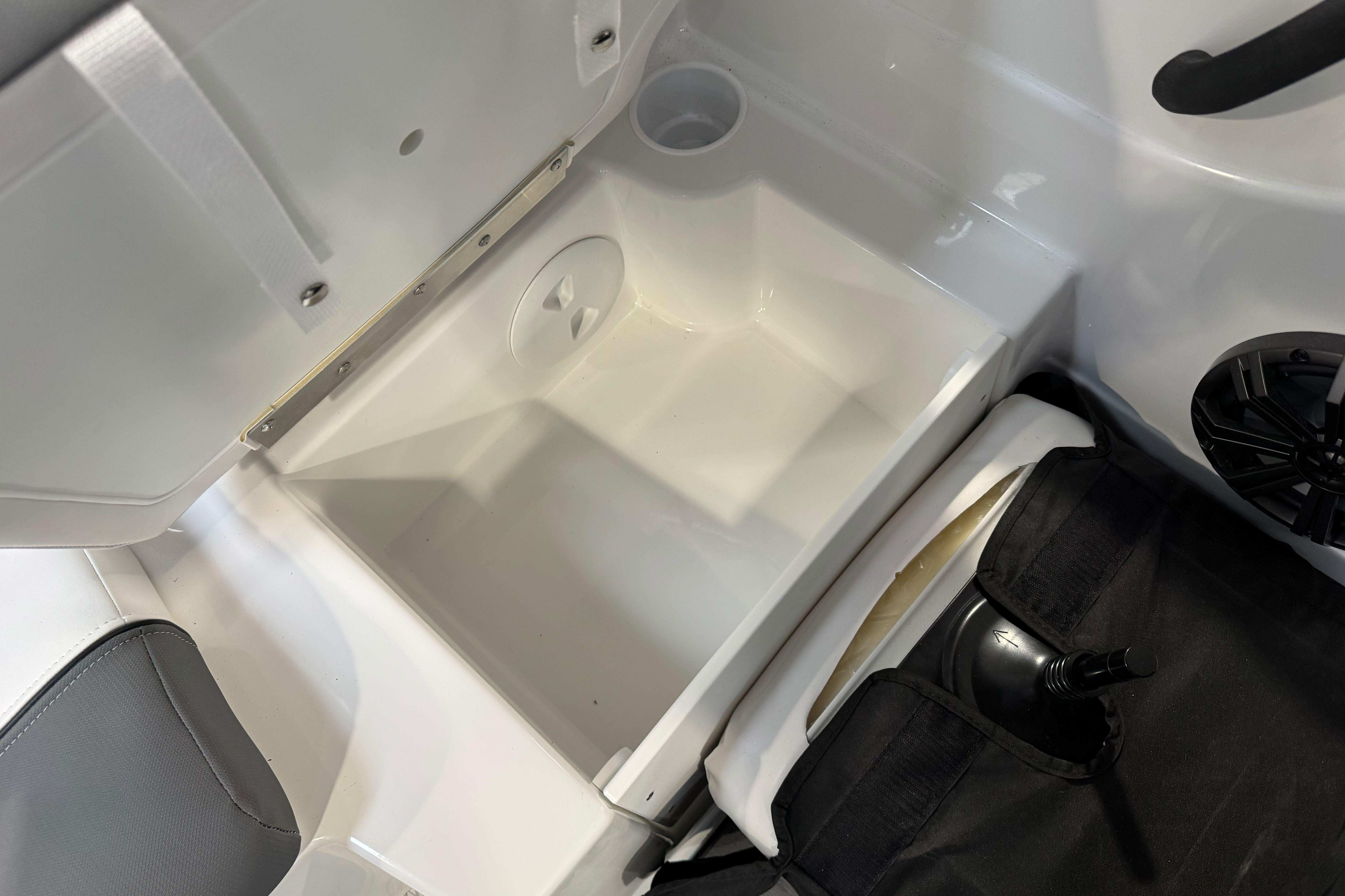 2026 Tahoe T21 boat storage compartment with open lid and speaker.