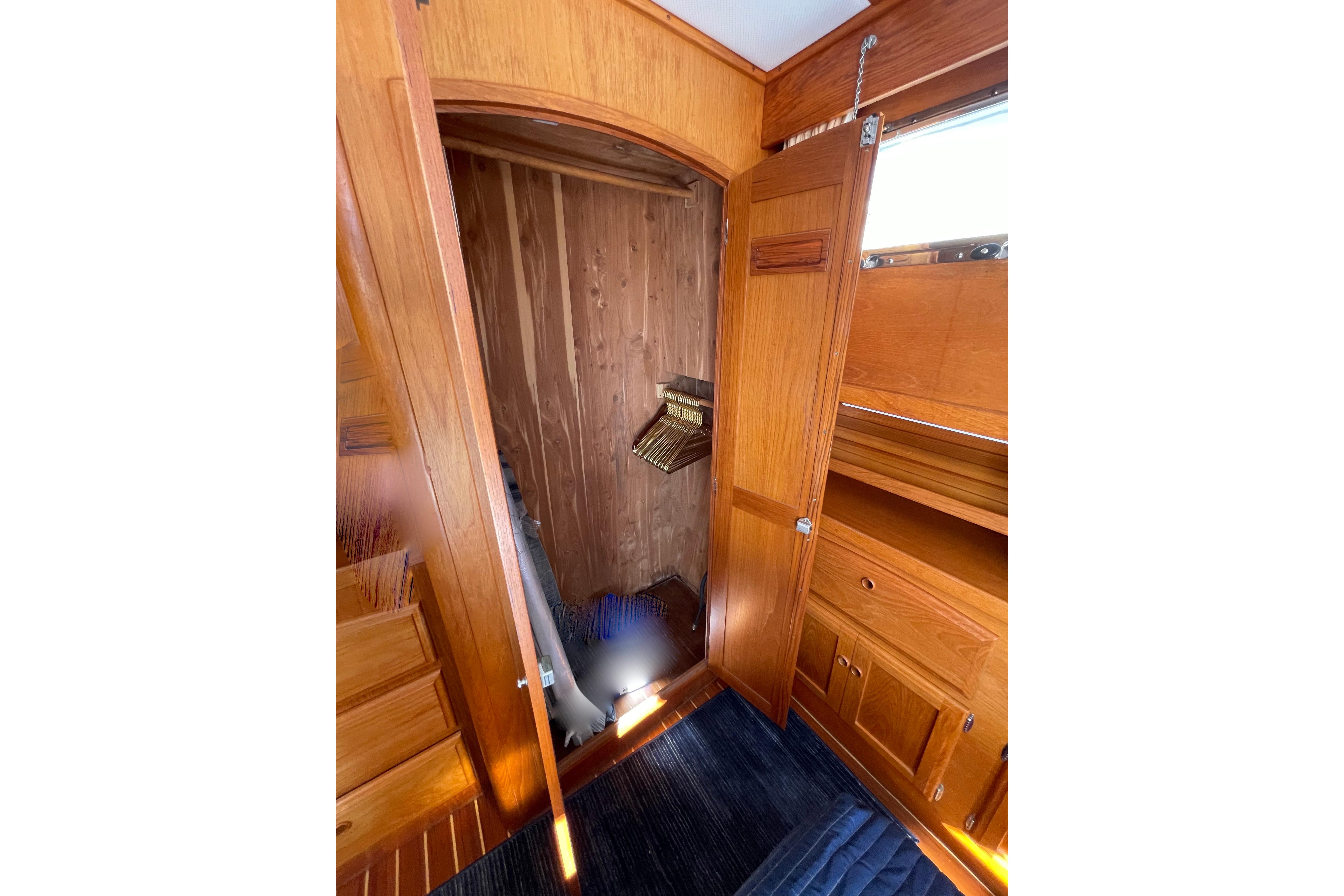 1997 Sabre interior with wooden cabinetry and open closet space.