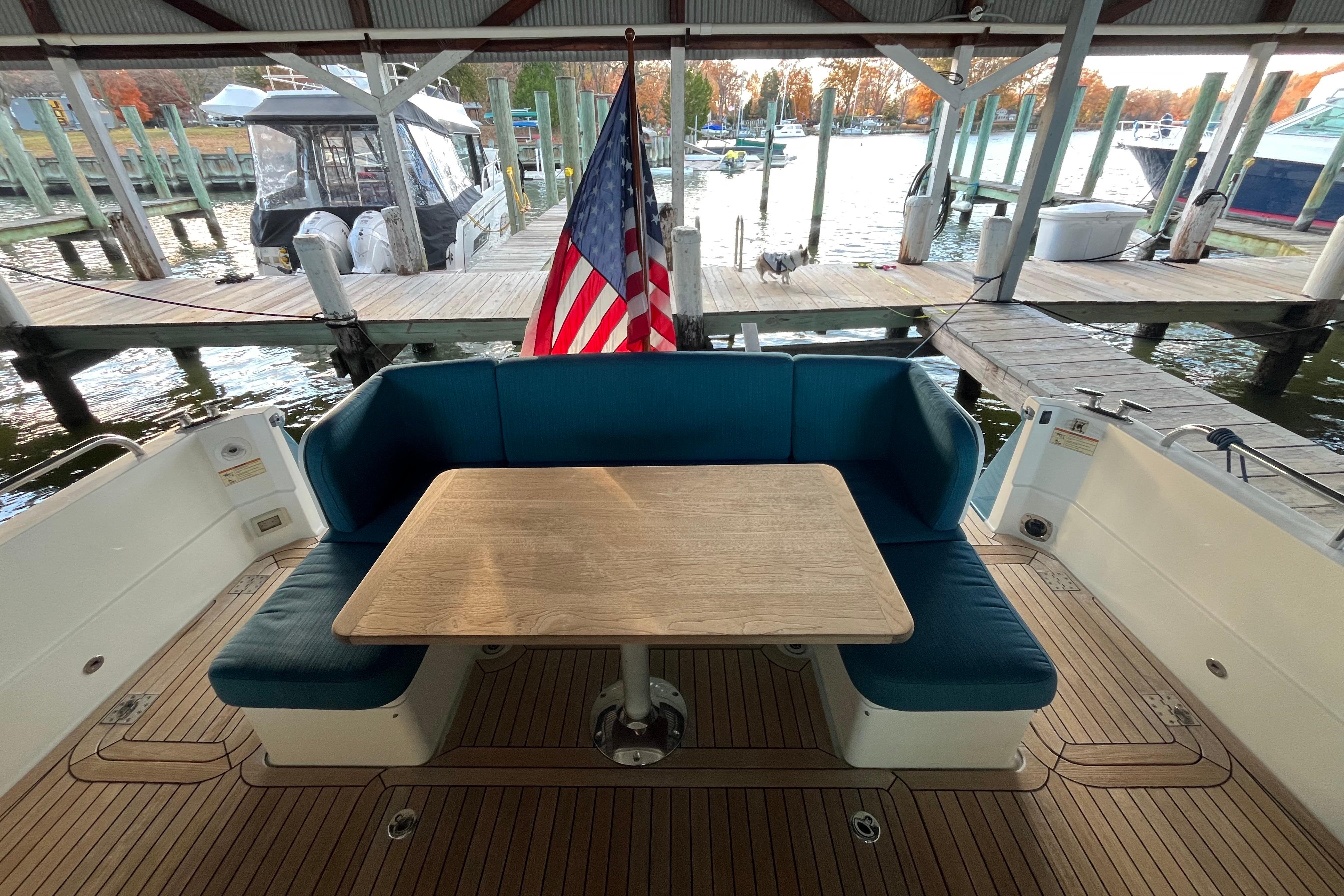 2019 Sabre 45 Salon Express yacht with outdoor seating and American flag at dock.
