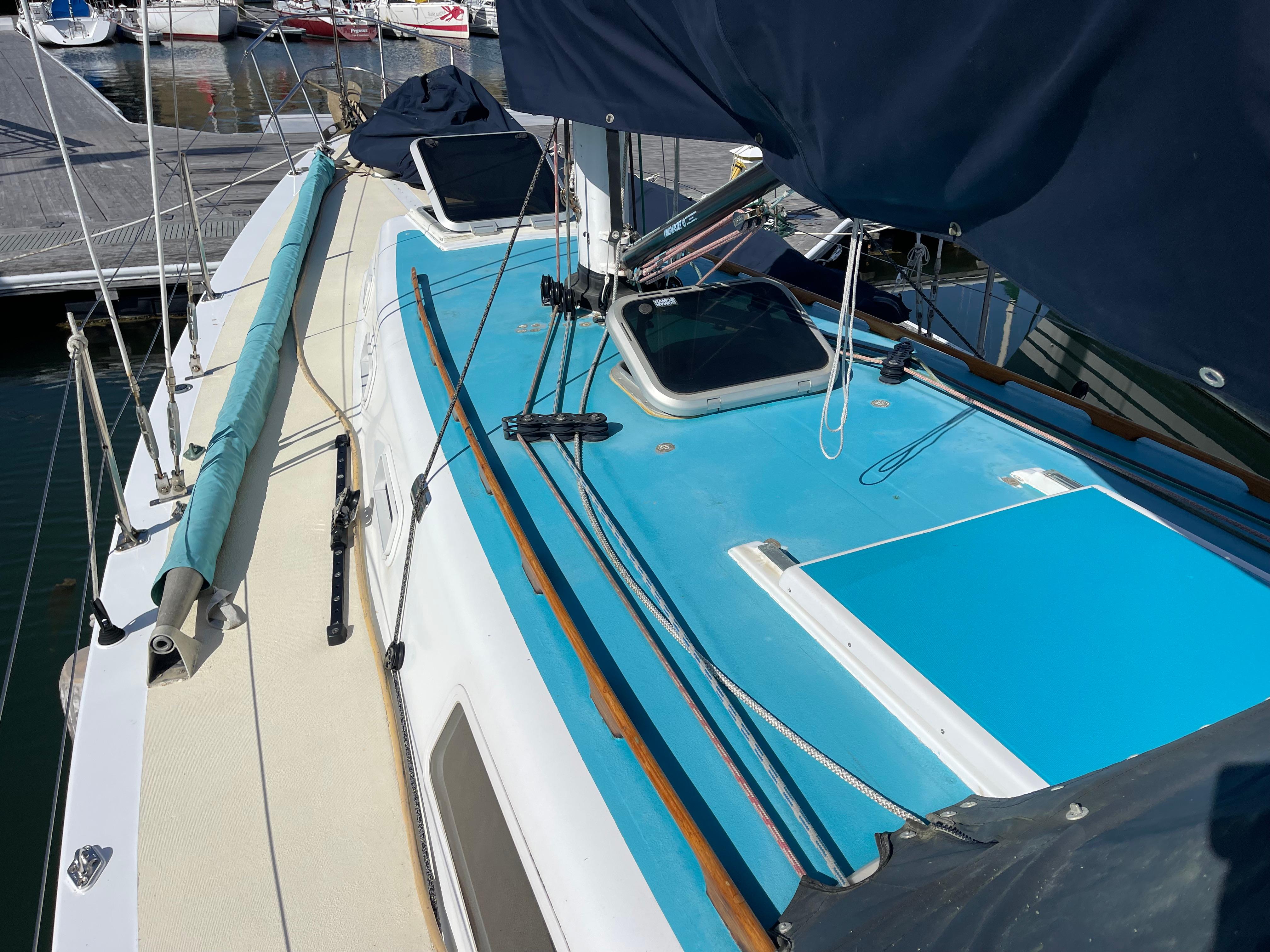 1964 CAL 40 sailboat deck with blue accents, docked at marina.