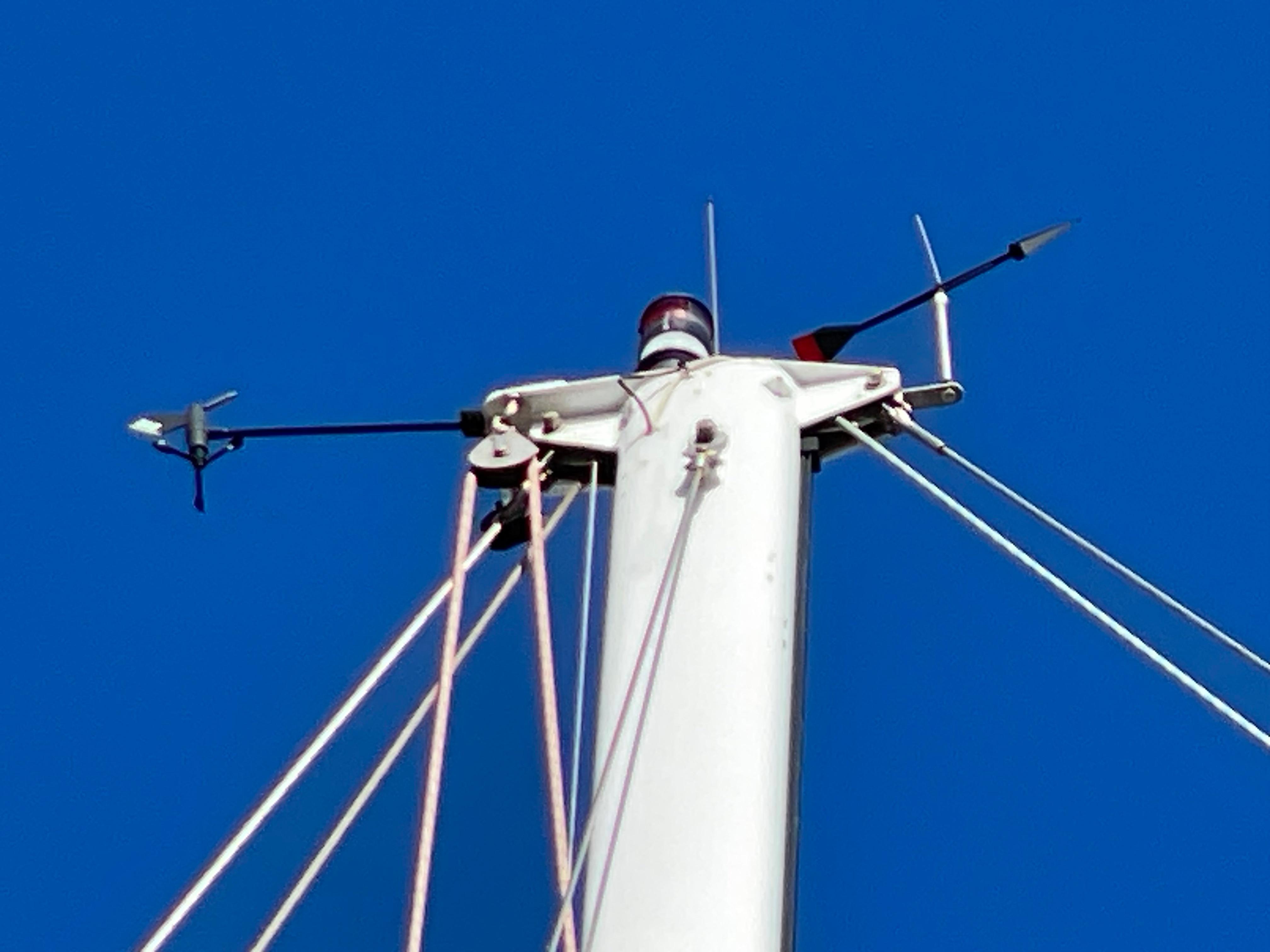 Mast top of 1964 CAL 40 sailboat against clear blue sky.