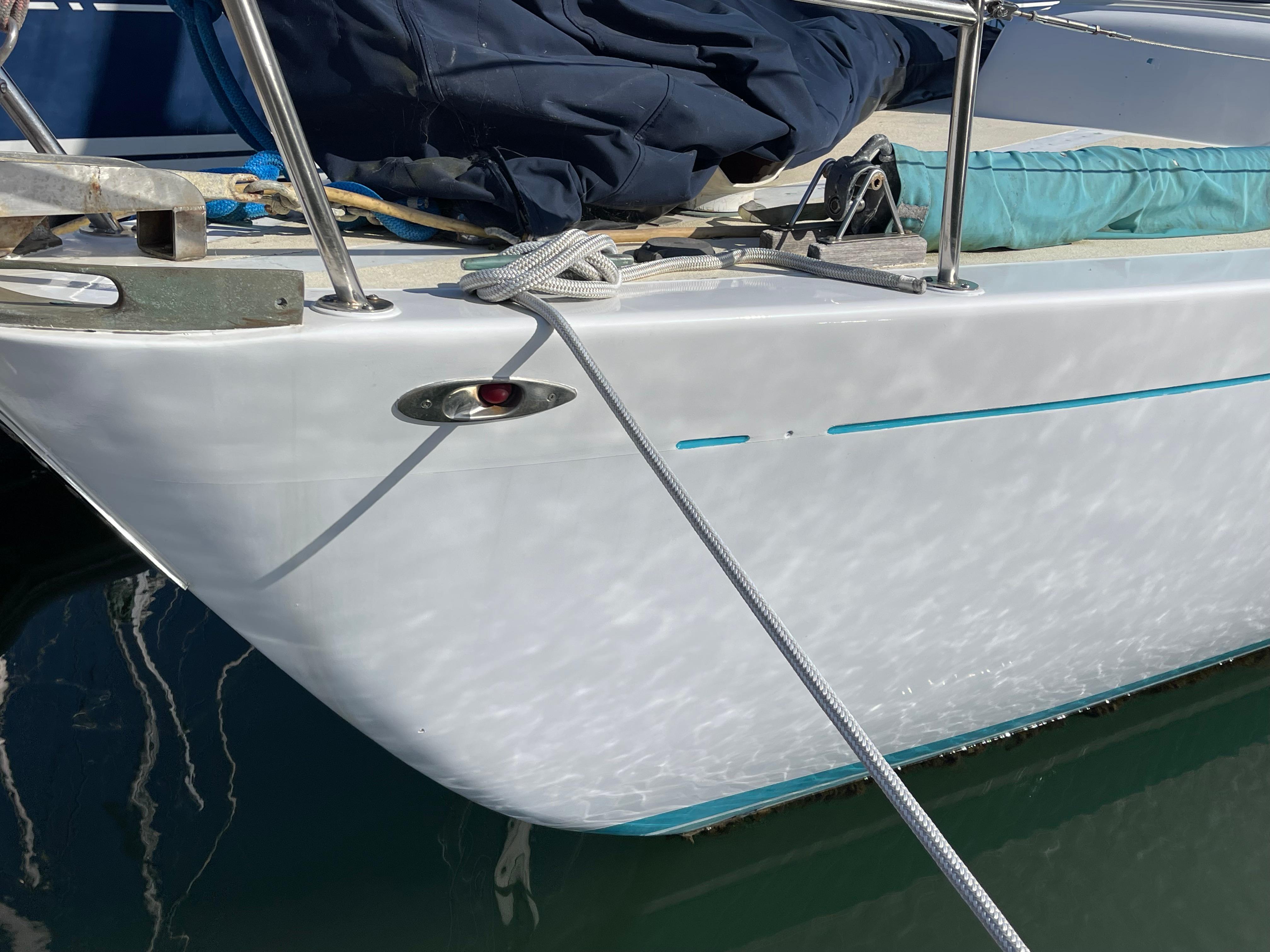 Close-up of a 1964 CAL 40 sailboat bow with ropes and nautical equipment.