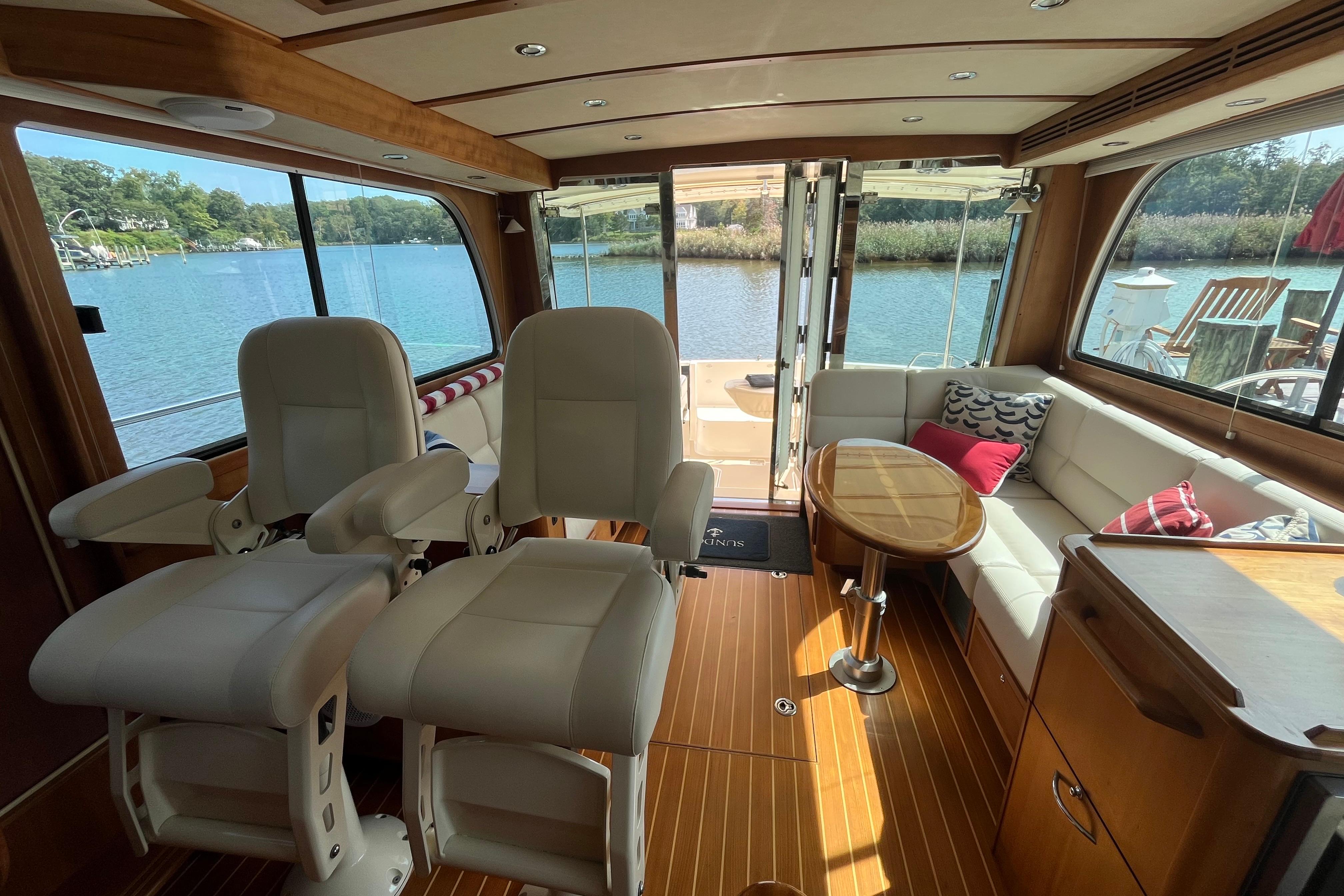 Interior of 2012 Sabre 42 Salon Express yacht with plush seating and scenic water view.
