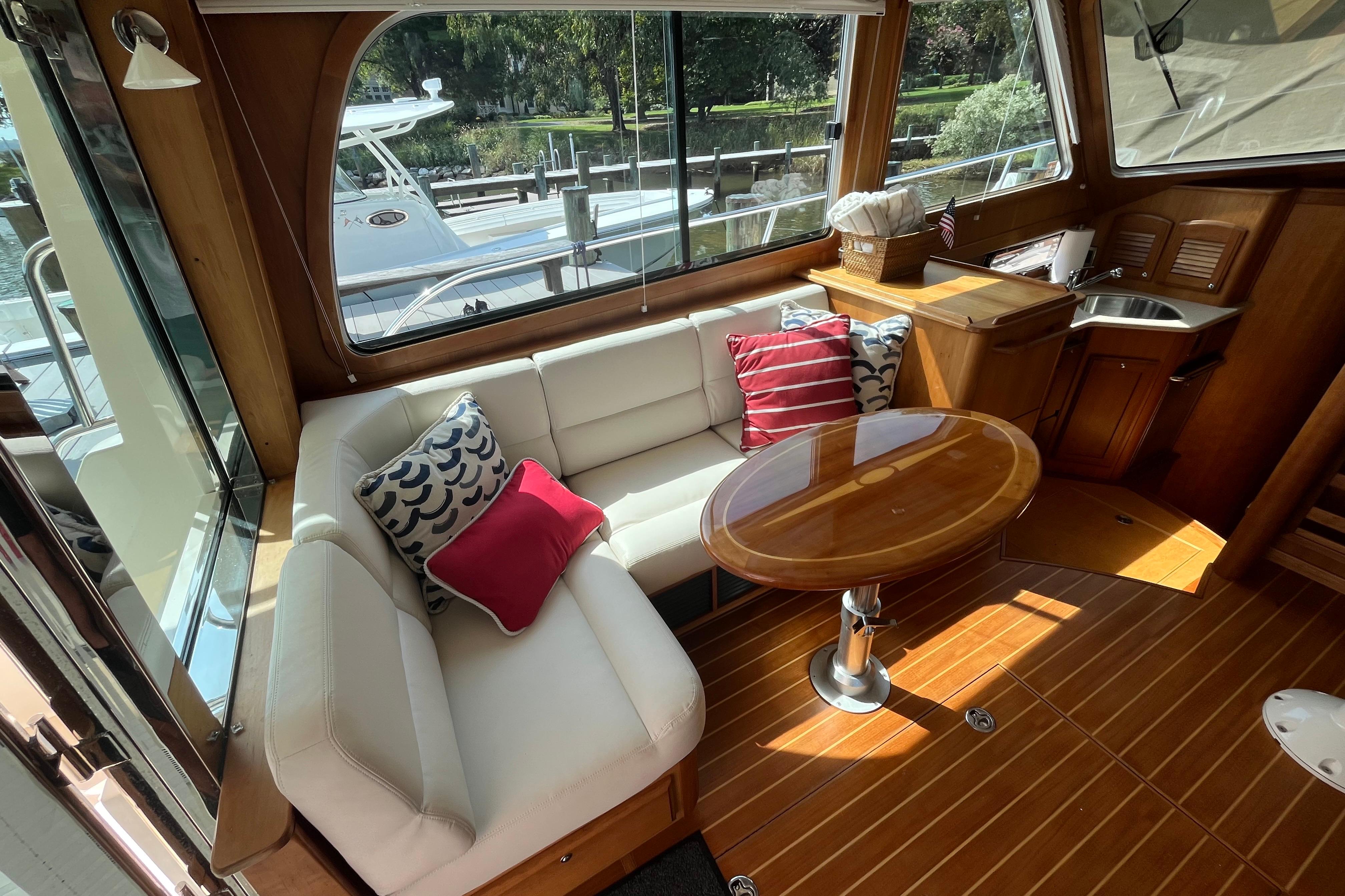 Interior of 2012 Sabre 42 Salon Express with cozy seating and wooden table.