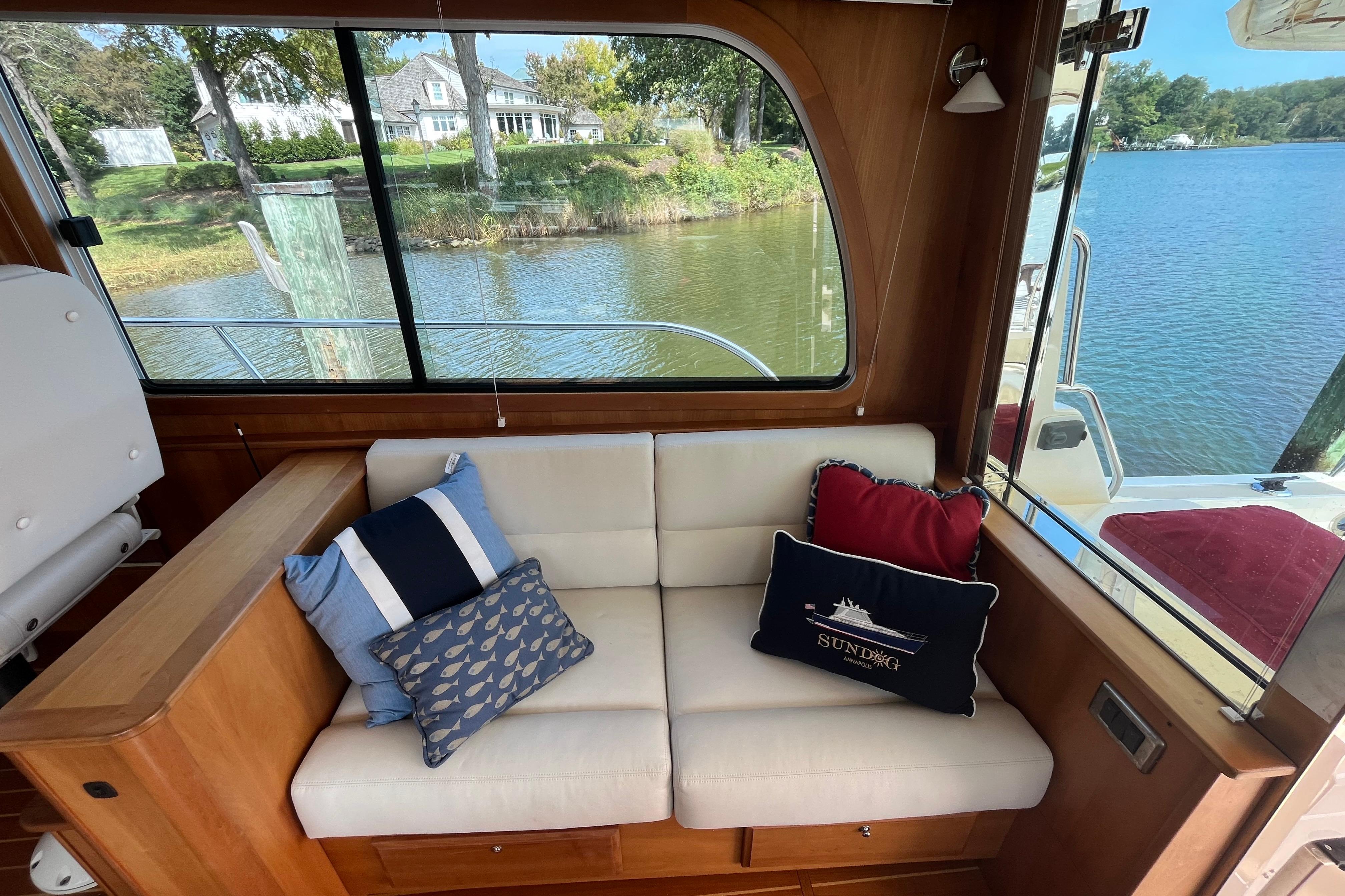 Interior of 2012 Sabre 42 Salon Express with cozy seating and decorative pillows.