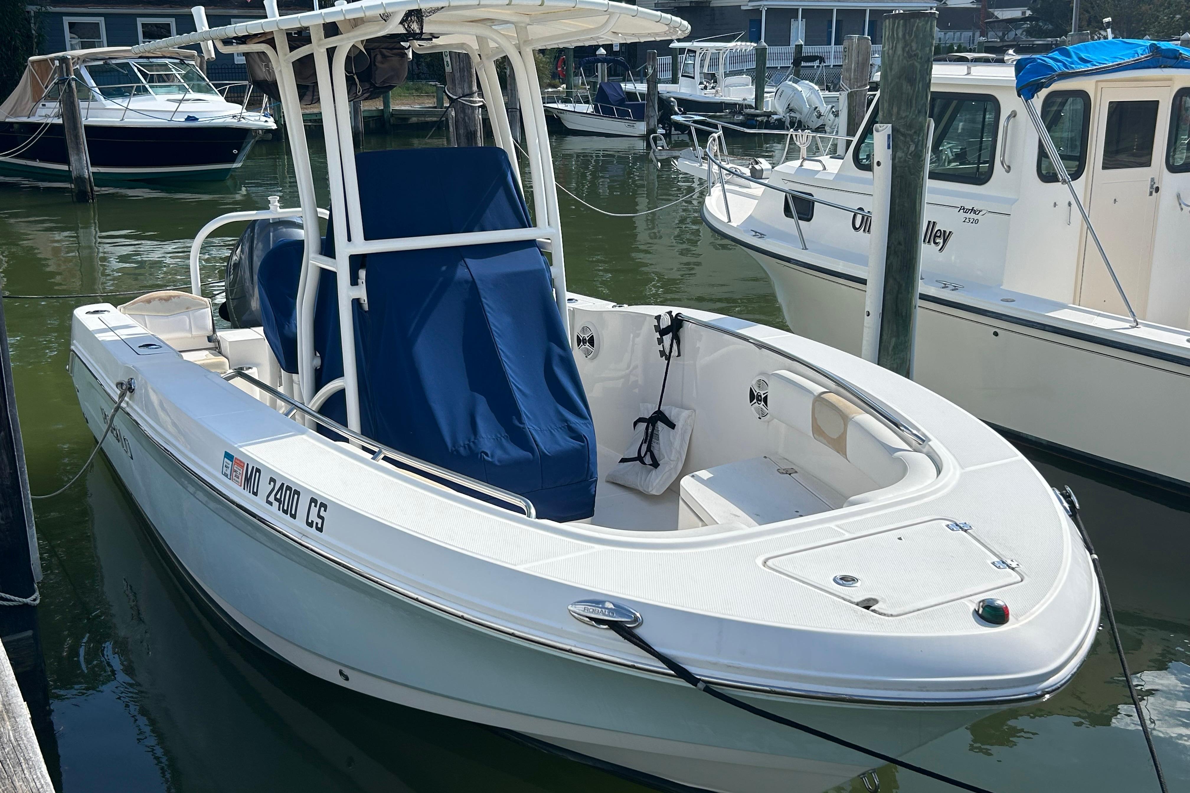 2016 Robalo R200 Center Console boat docked in a marina.