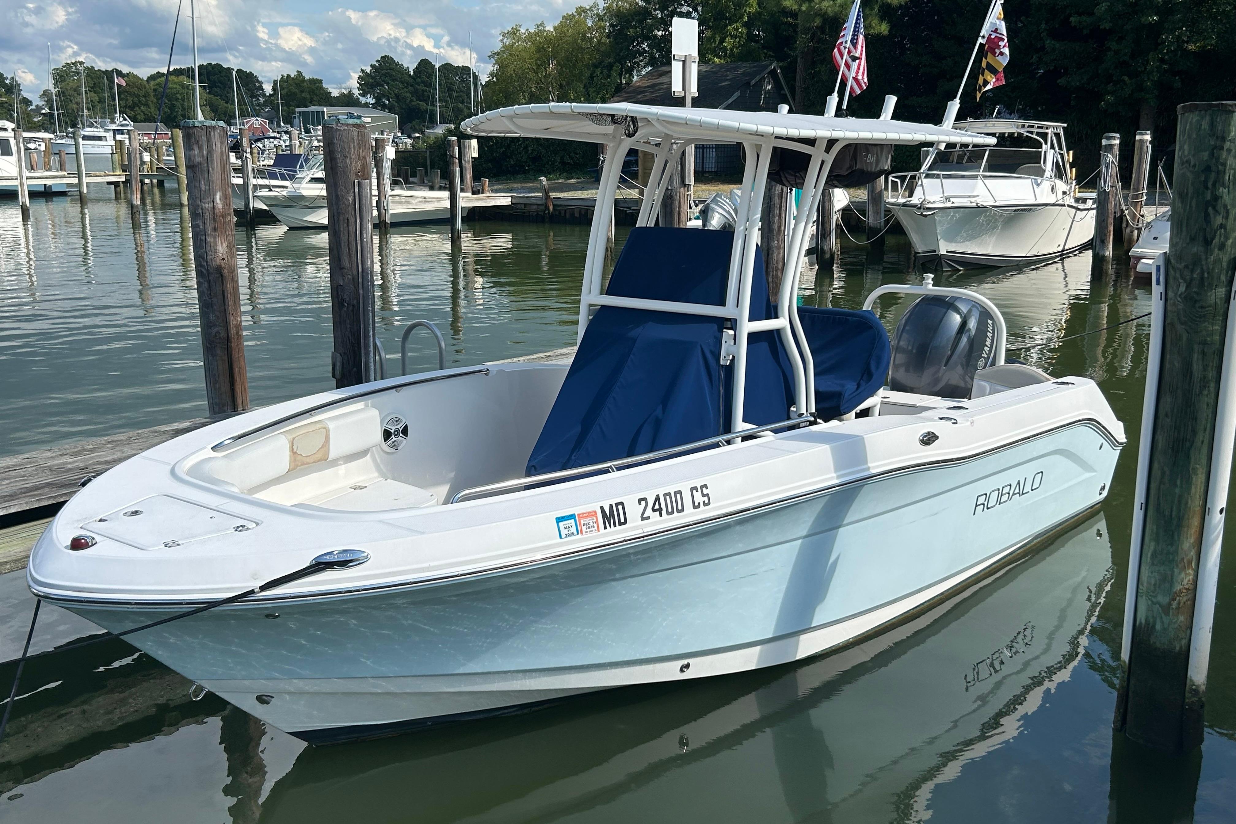 2016 Robalo R200 Center Console boat docked in a marina, calm water, clear sky.