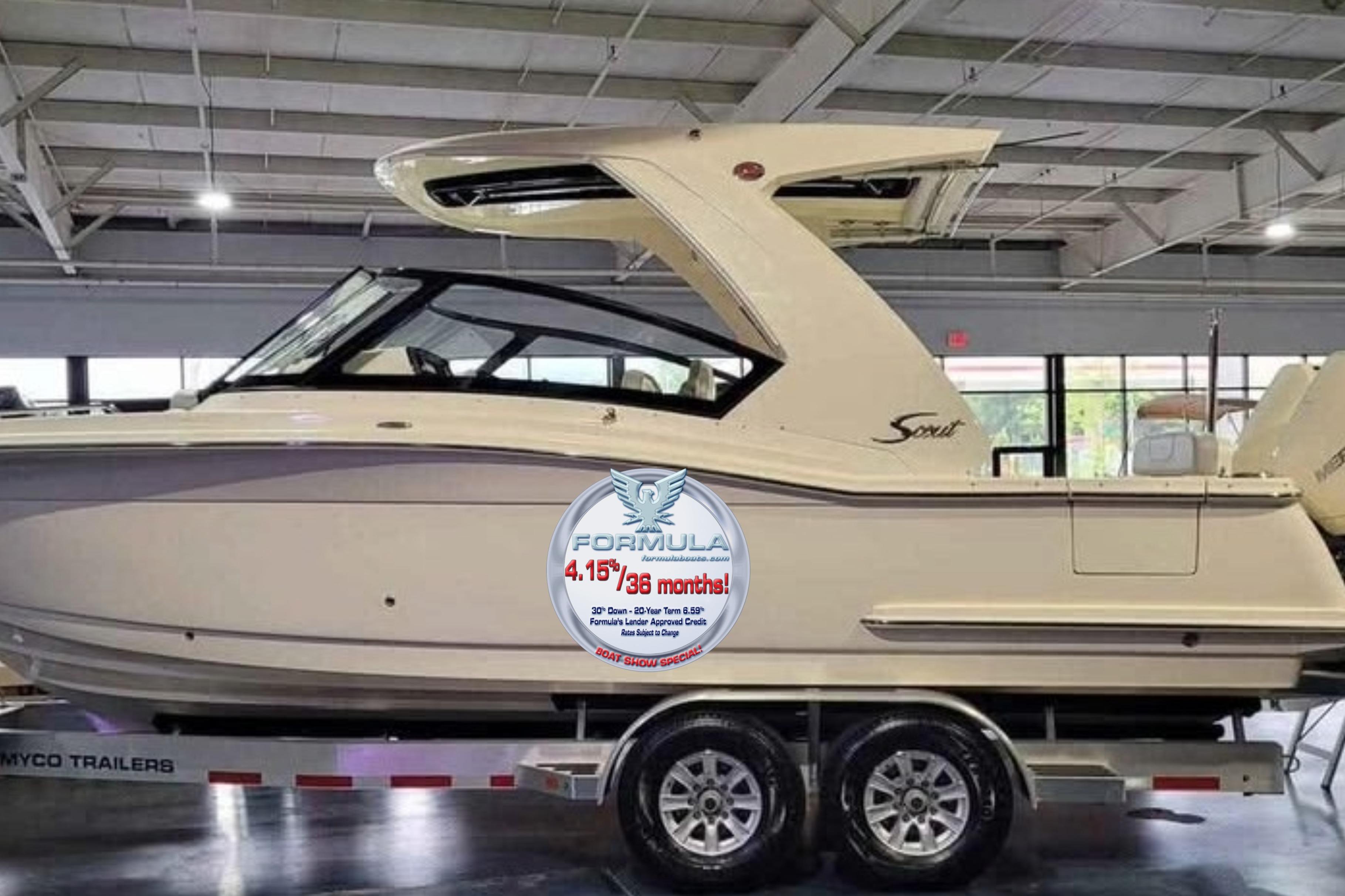 2021 Scout 277 Dorado boat on trailer in showroom, promotional offer displayed.