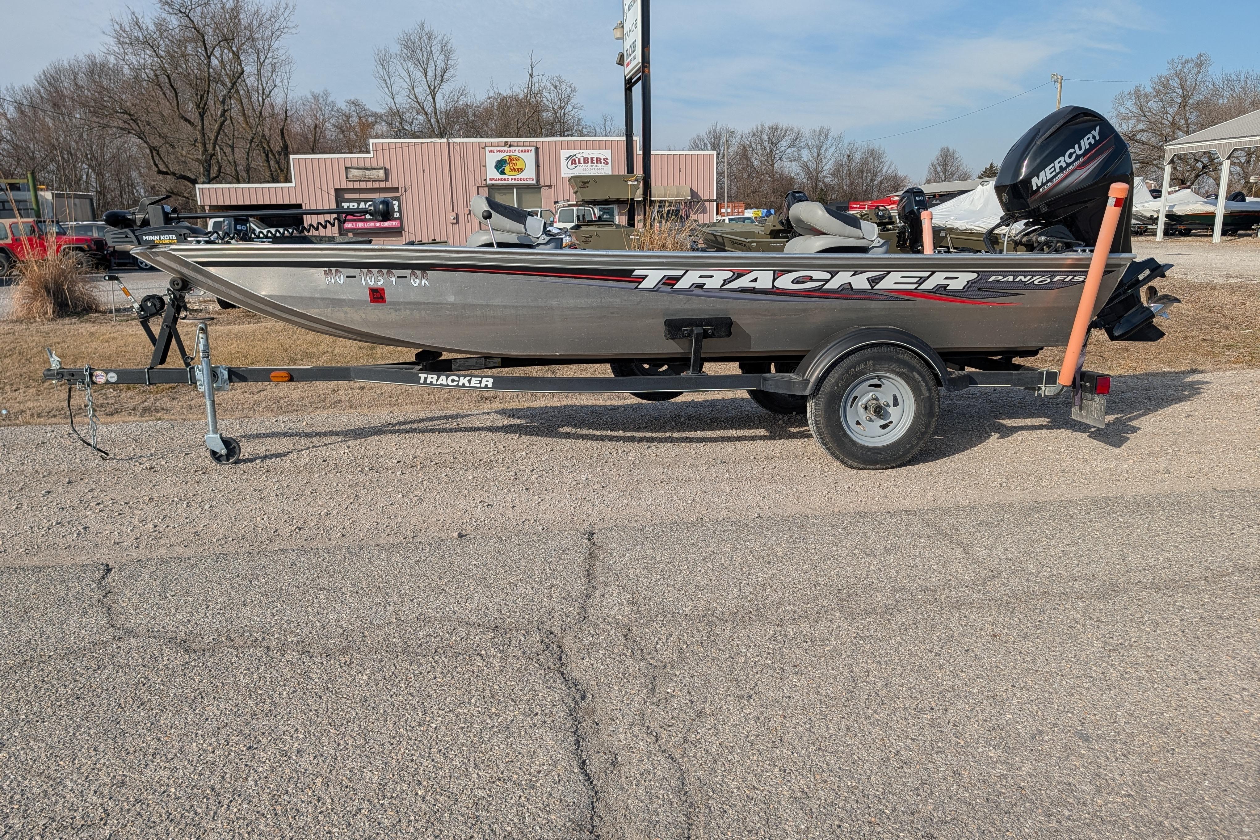 2017 Tracker Panfish 16 boat on trailer, parked outdoors with Mercury motor.
