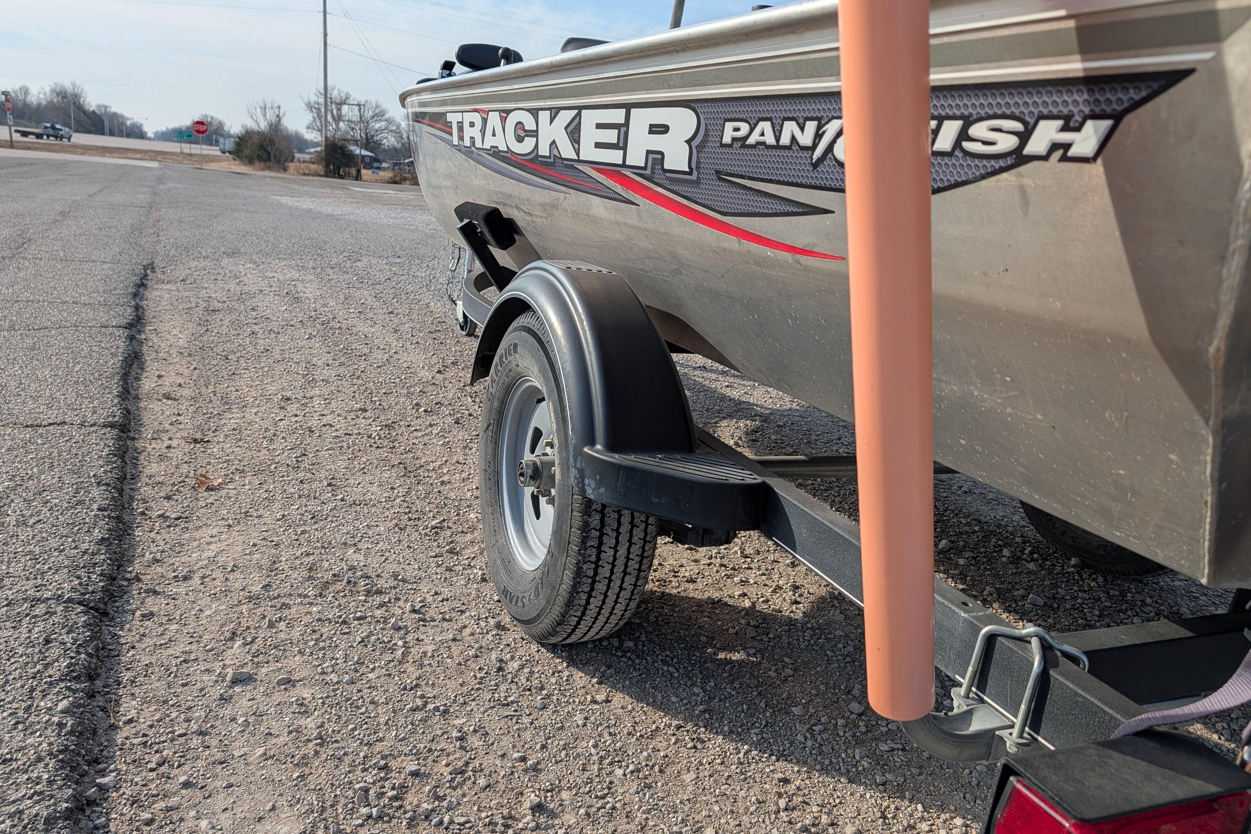 2017 Tracker Panfish 16 boat on trailer, parked on gravel roadside.