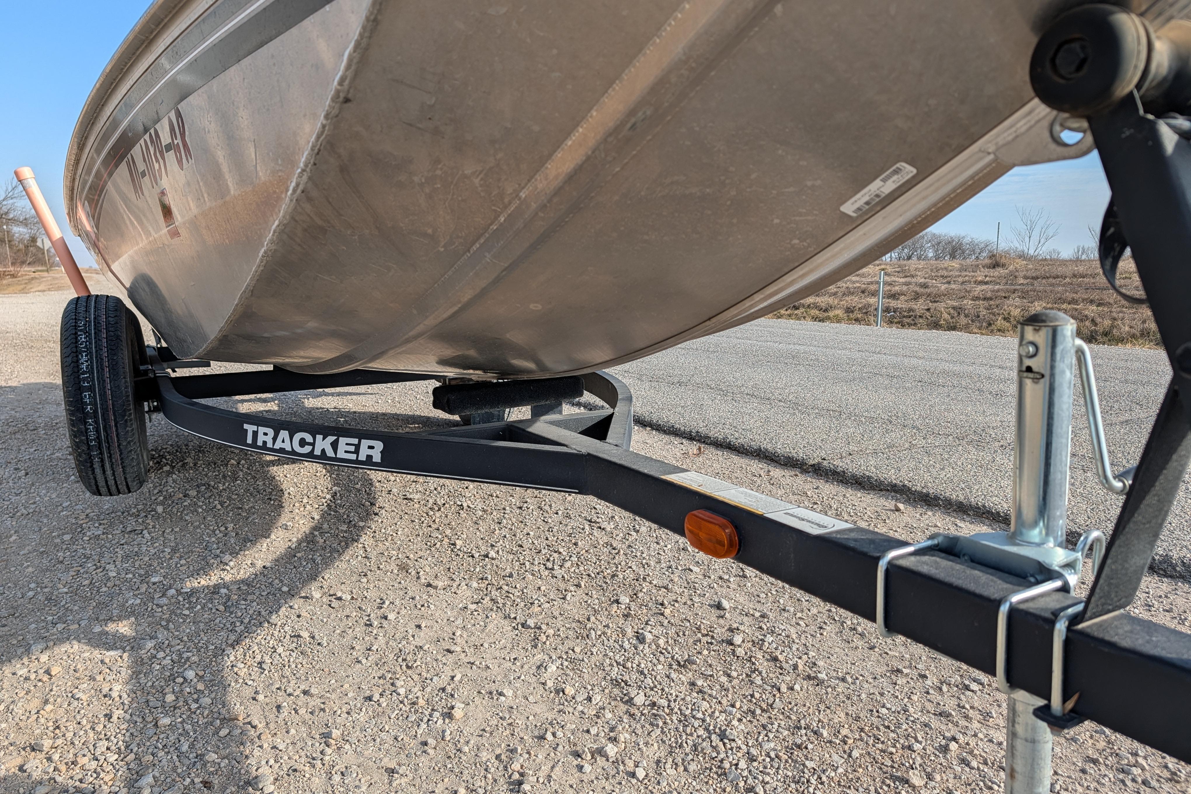 2017 Tracker Panfish 16 boat on trailer, parked on gravel road.