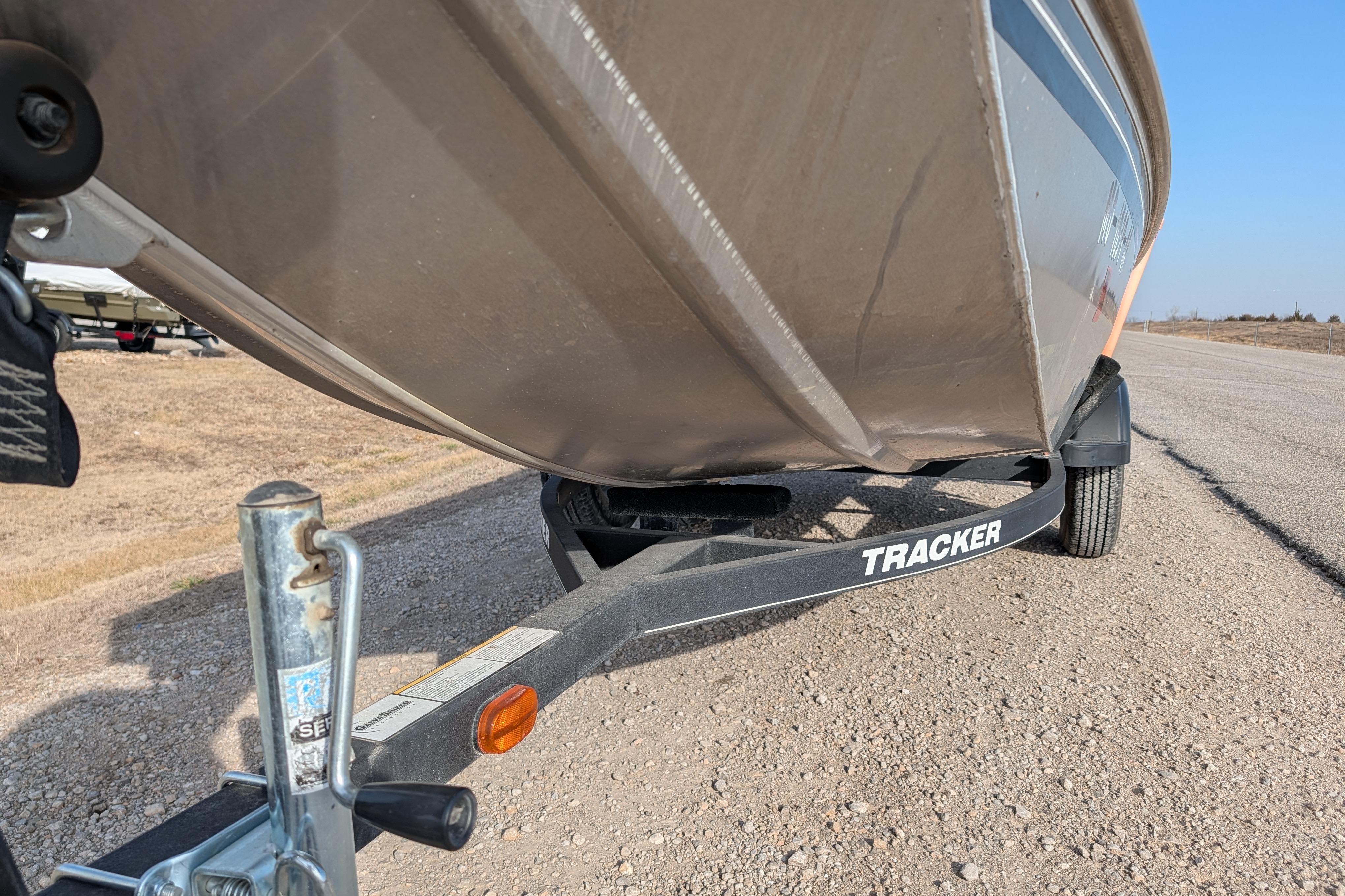 2017 Tracker Panfish 16 boat on trailer, parked on a gravel road.
