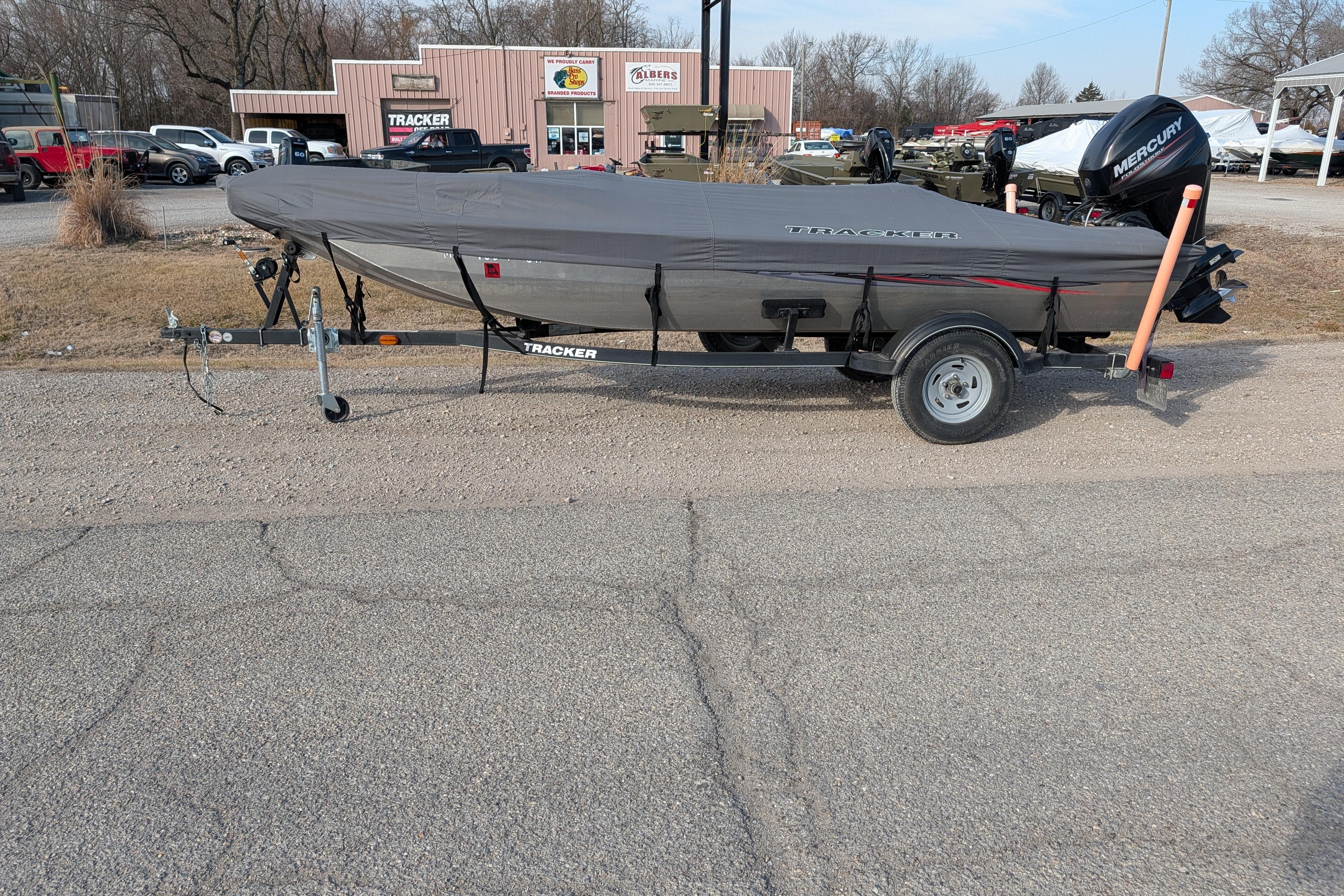2017 Tracker Panfish 16 boat on trailer, covered, parked outdoors.