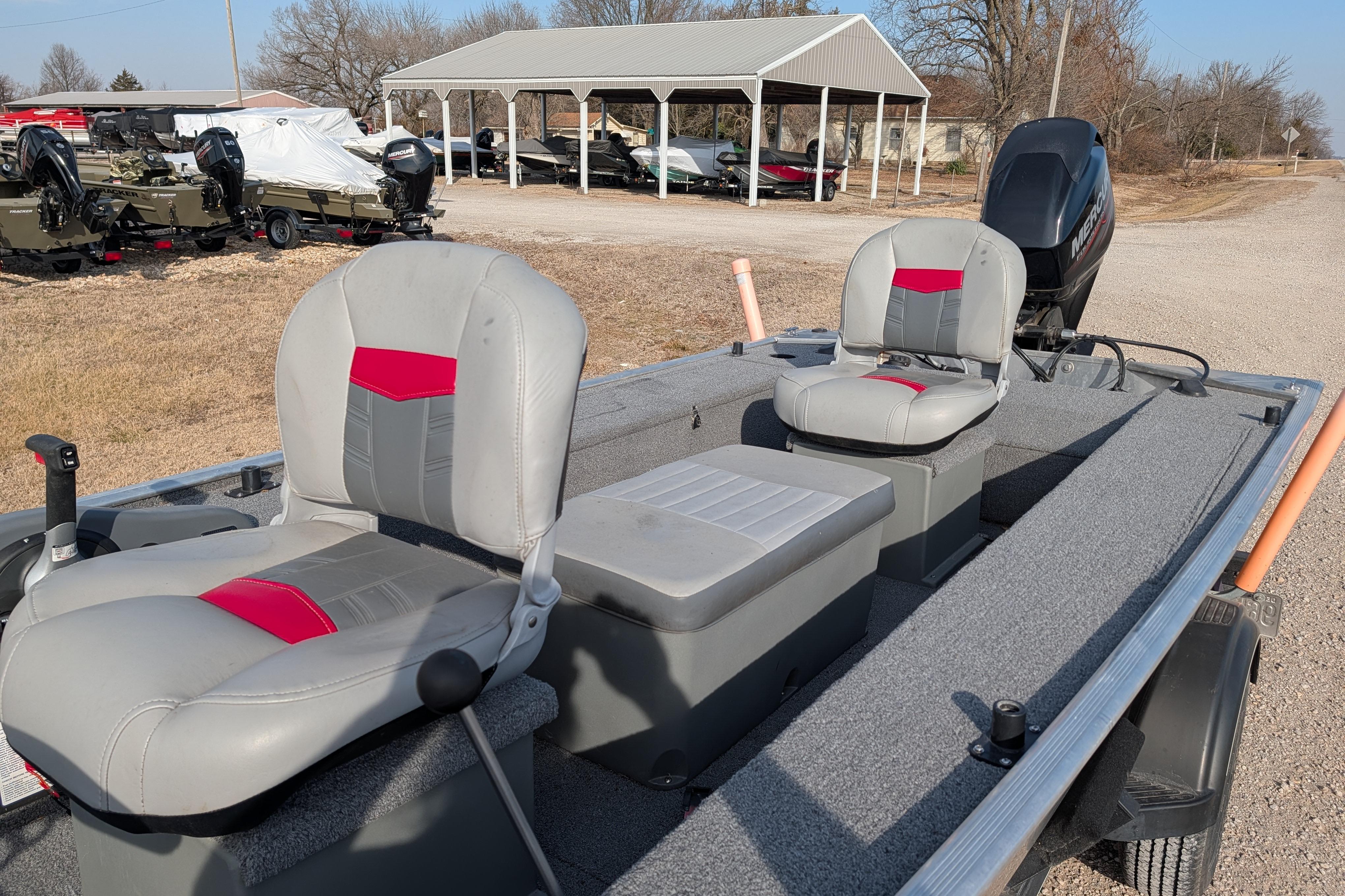 2017 Tracker Panfish 16 boat with dual seats and outboard motor in a rural setting.