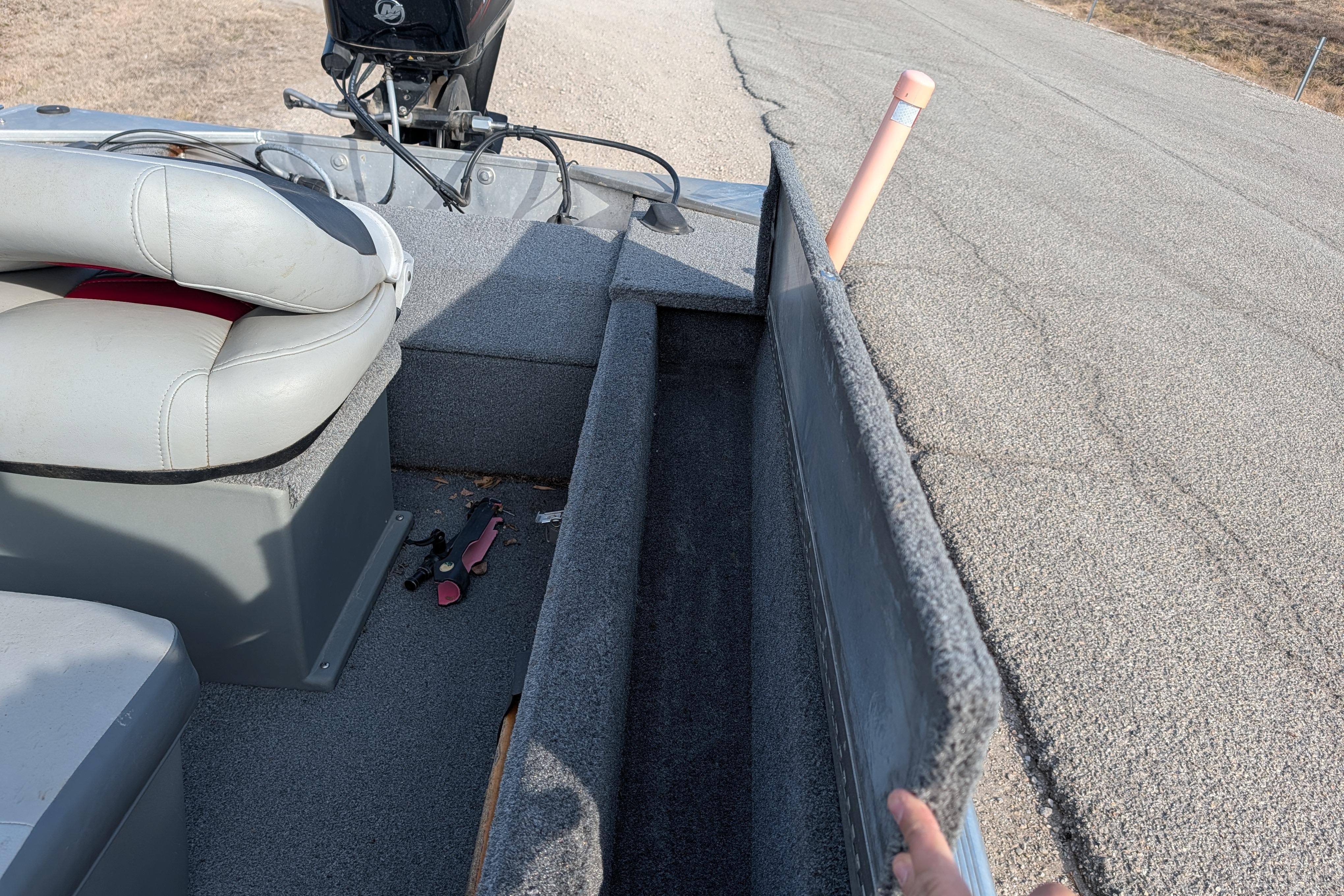 2017 Tracker Panfish 16 boat interior with storage compartment open, showing seating and equipment.