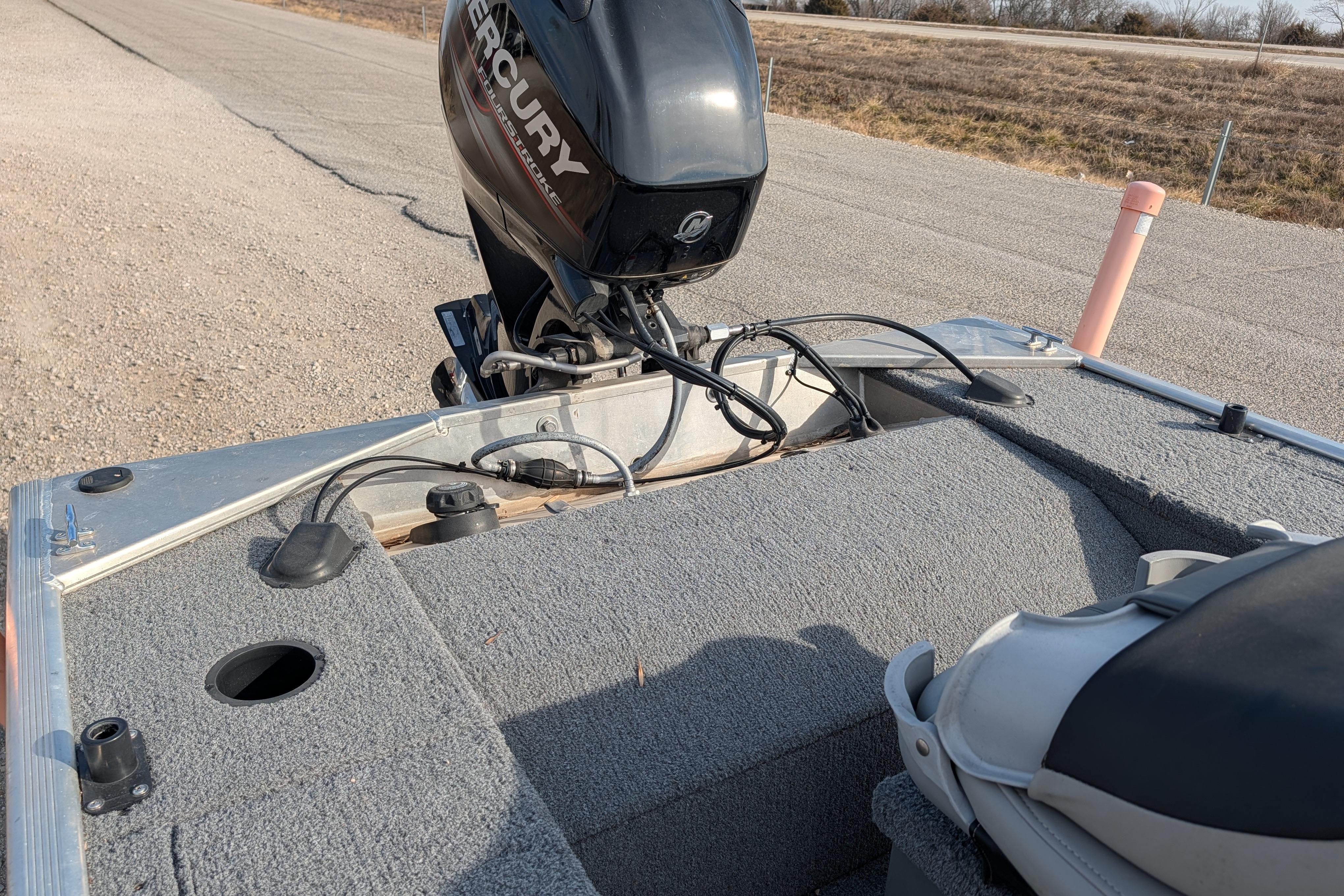 2017 Tracker Panfish 16 boat with Mercury outboard motor on a paved road.
