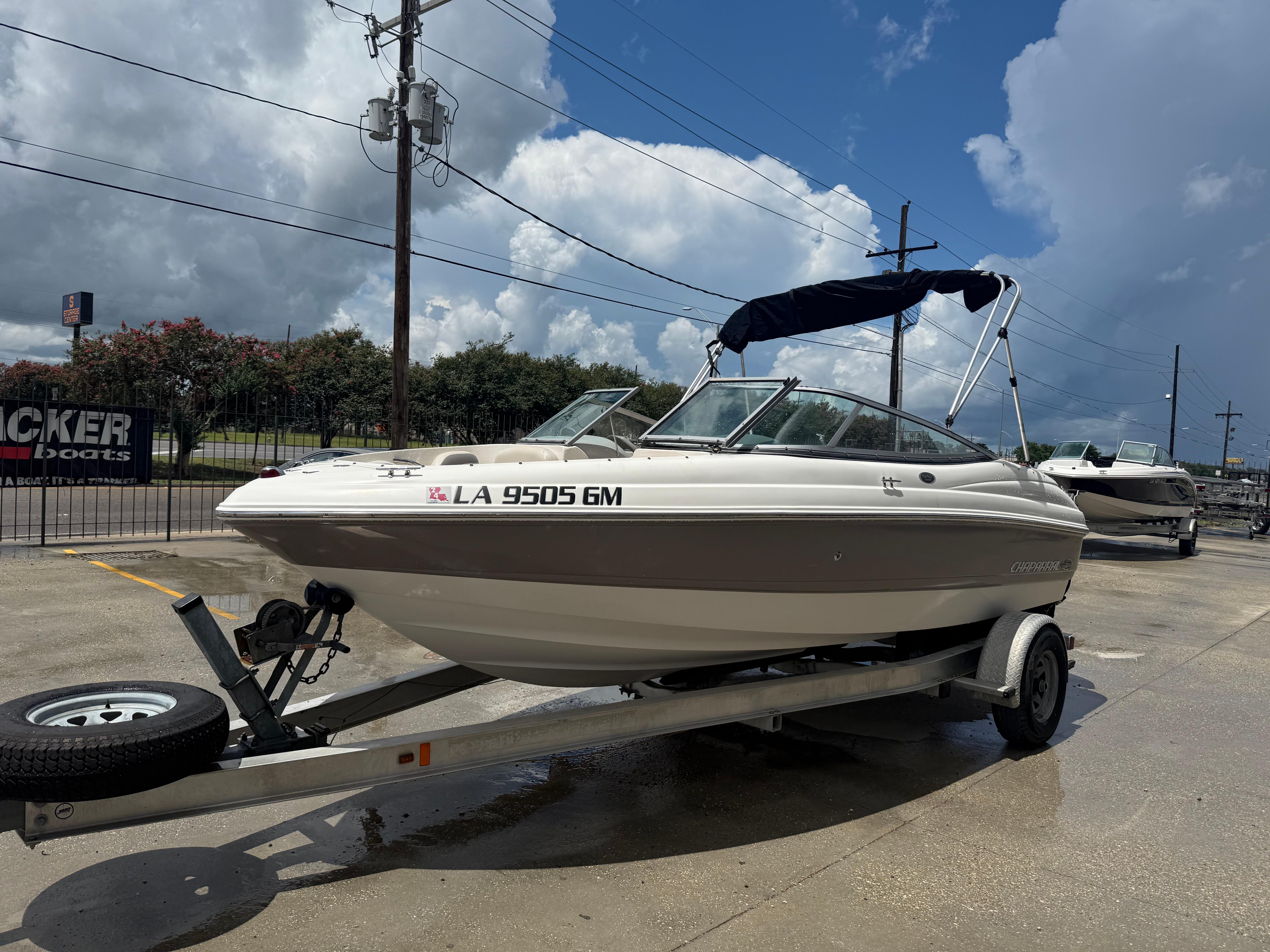 2007 Chaparral 190 SSi boat on trailer under cloudy sky.