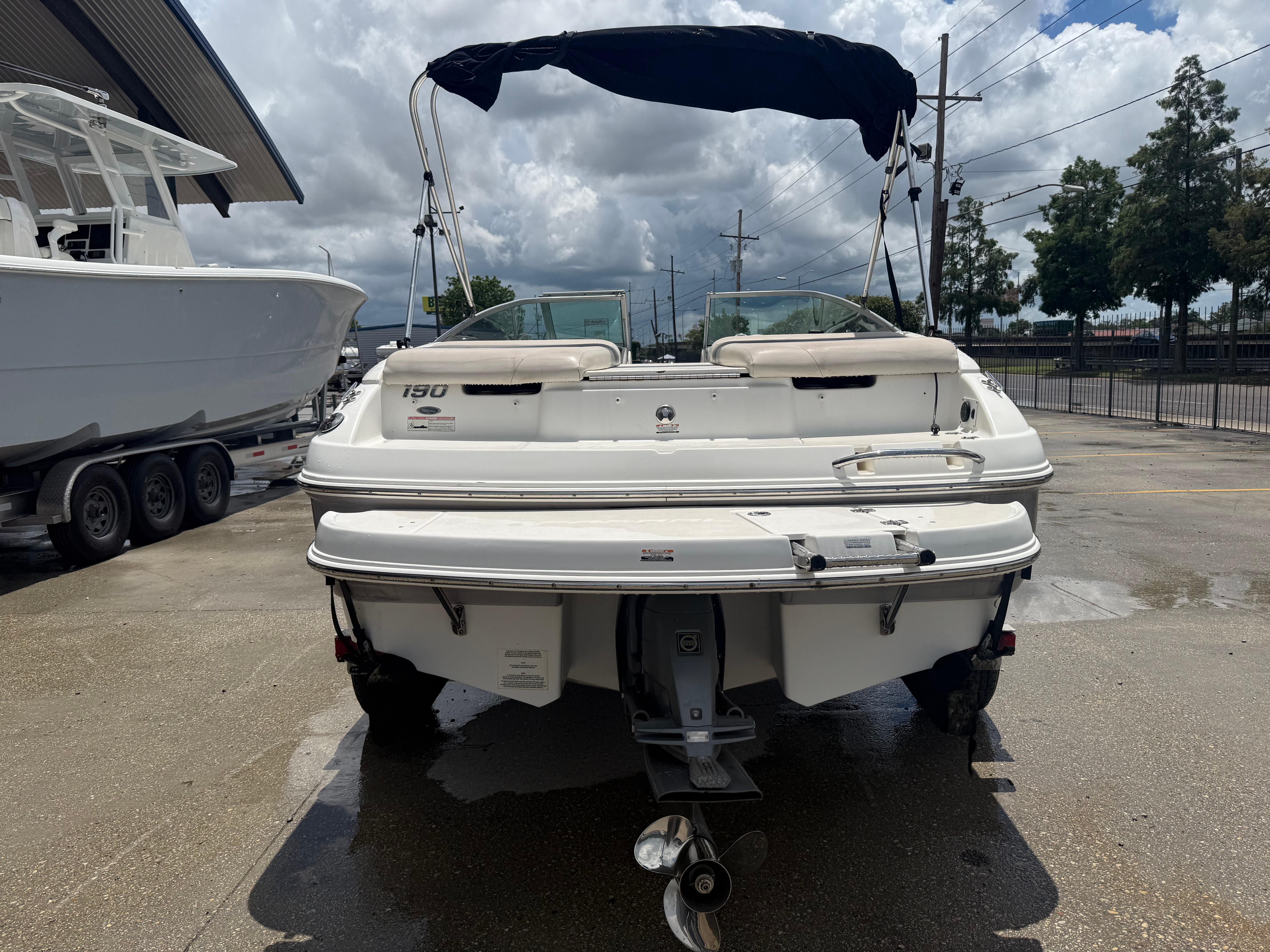 2007 Chaparral 190 SSi boat, rear view, parked outdoors on a cloudy day.