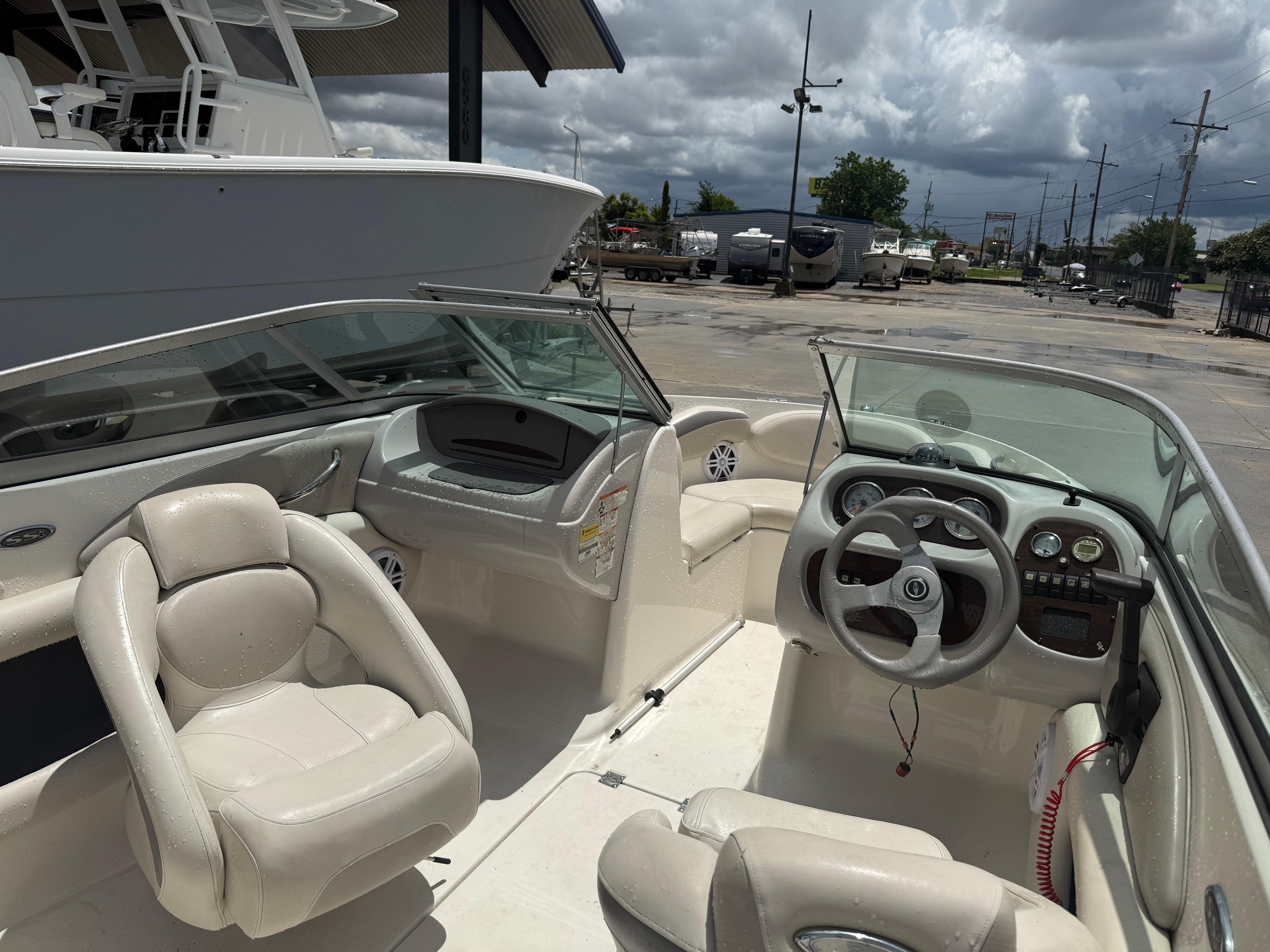 2007 Chaparral 190 SSi boat interior with steering wheel and seating under cloudy sky.