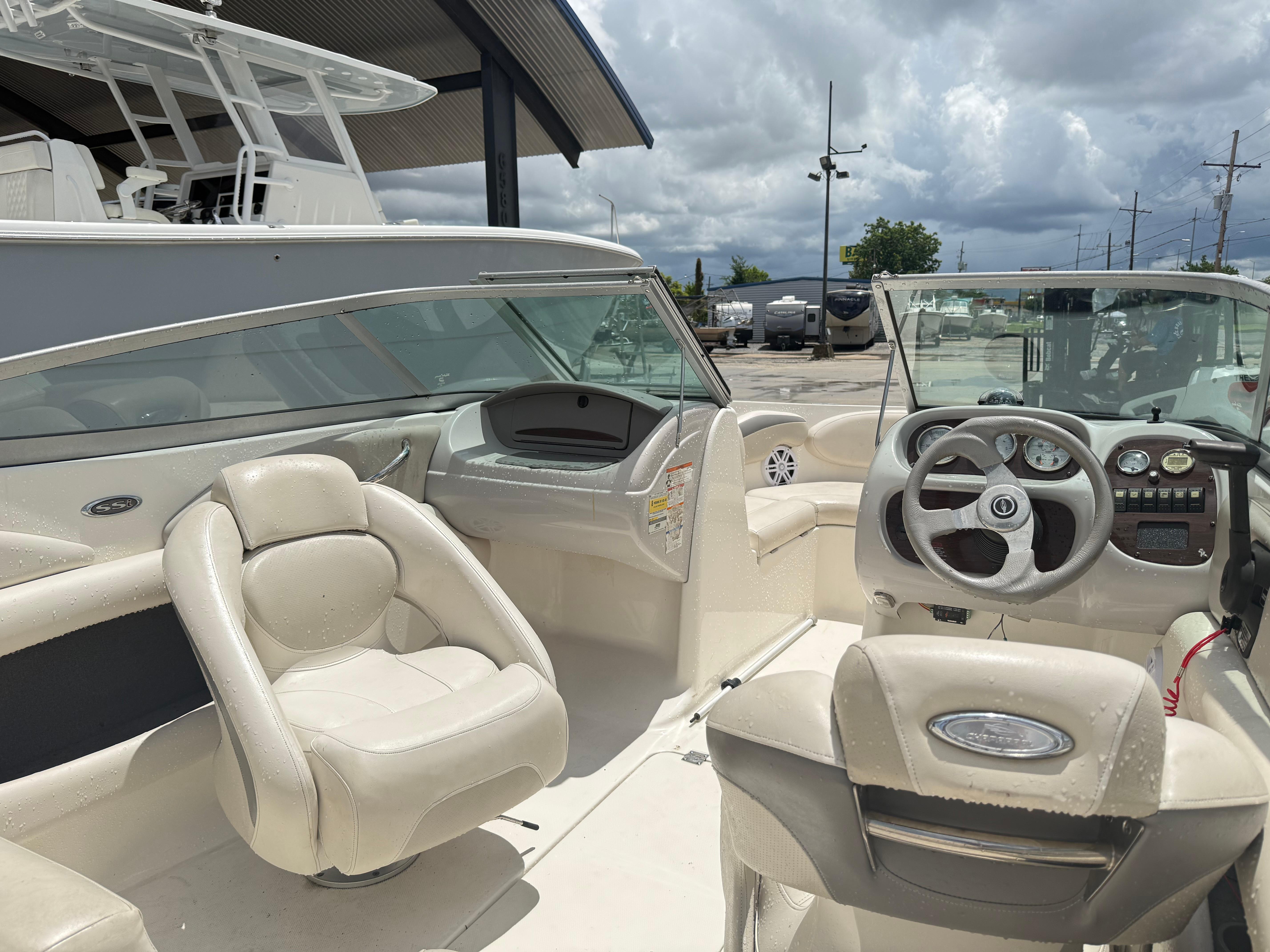 2007 Chaparral 190 SSi boat interior with steering wheel and seating under cloudy sky.