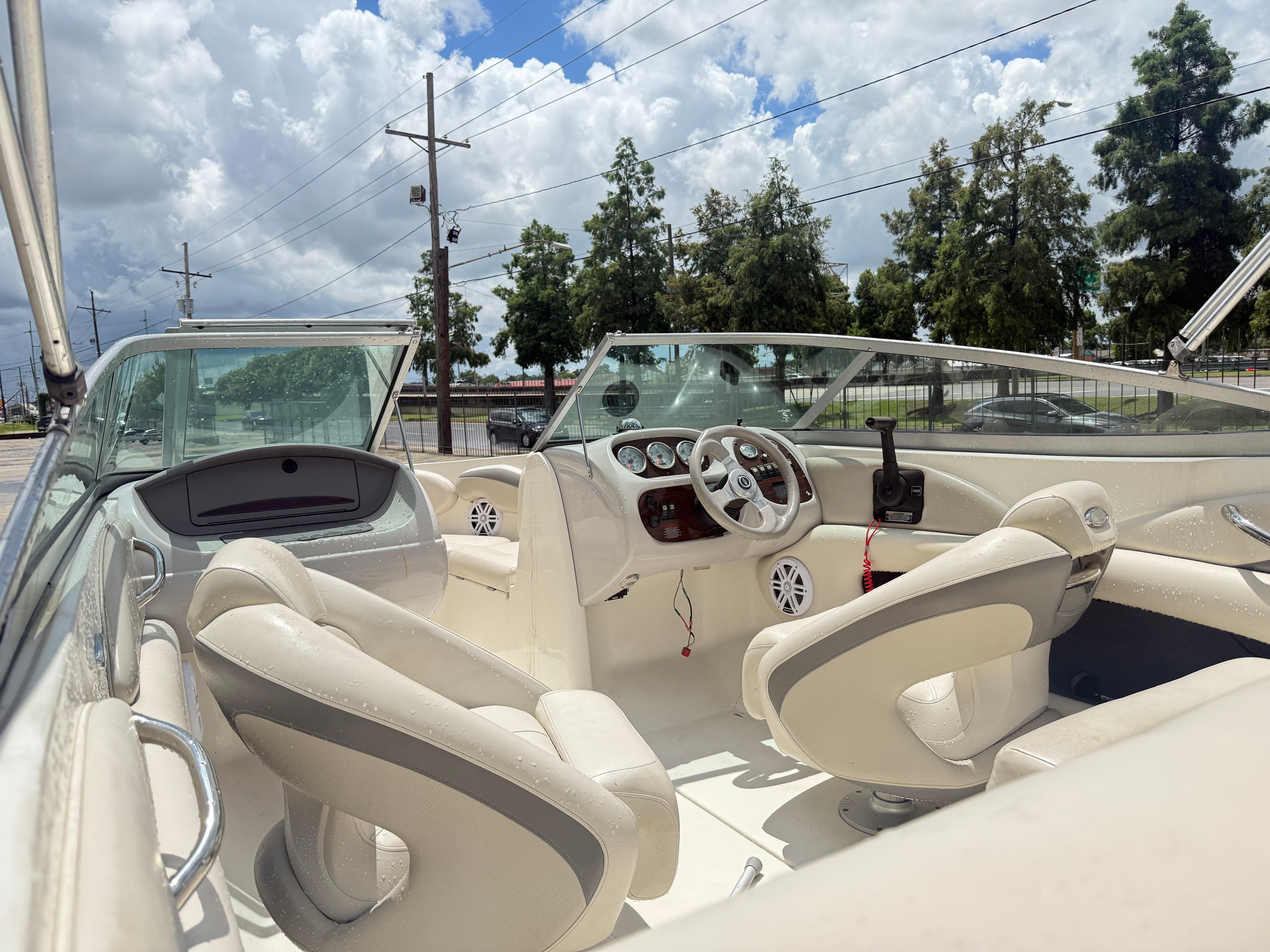 2007 Chaparral 190 SSi boat interior with white seating and dashboard under cloudy sky.