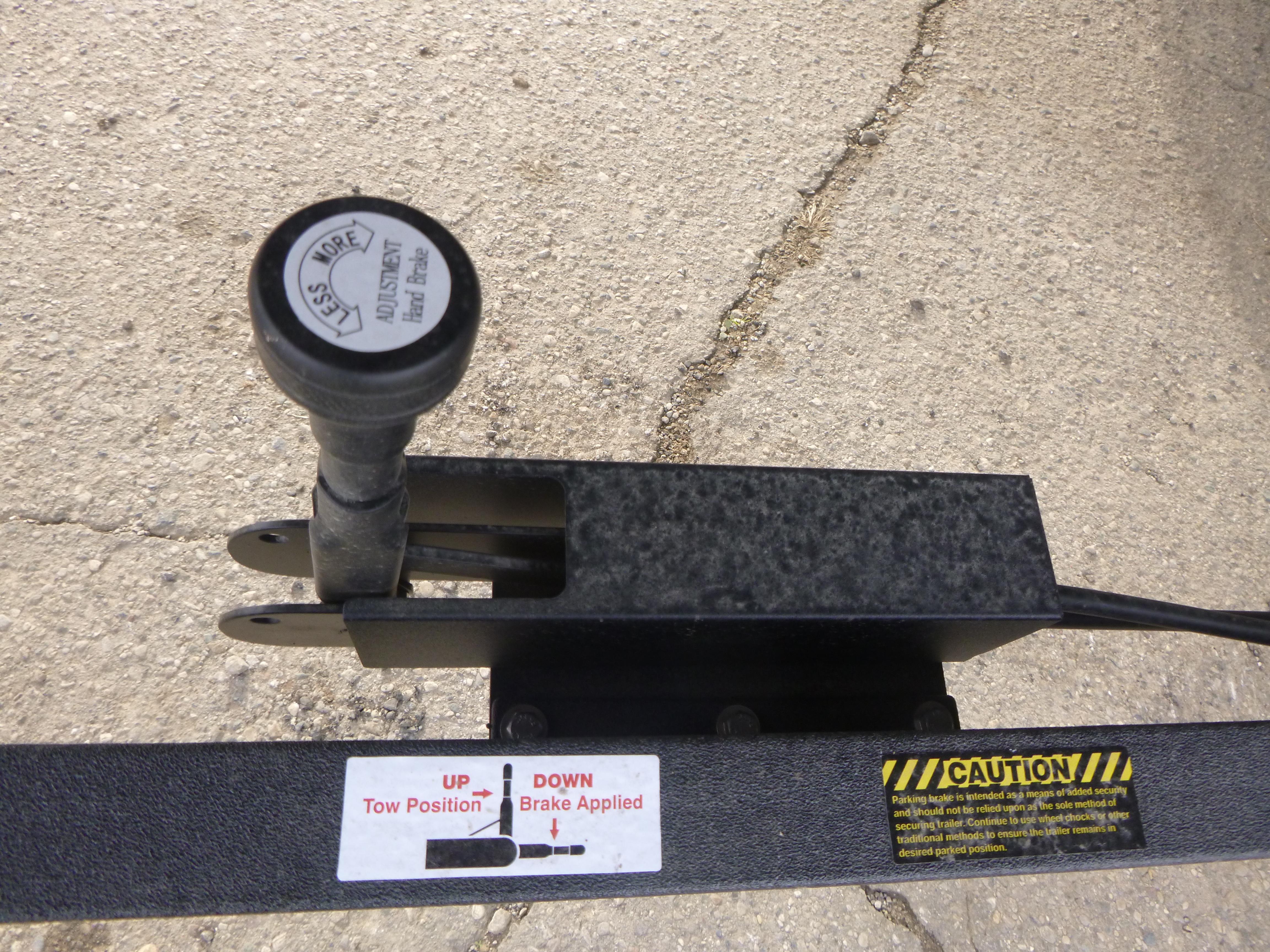 2025 Ranger 621FS trailer brake lever on textured surface, with caution label.