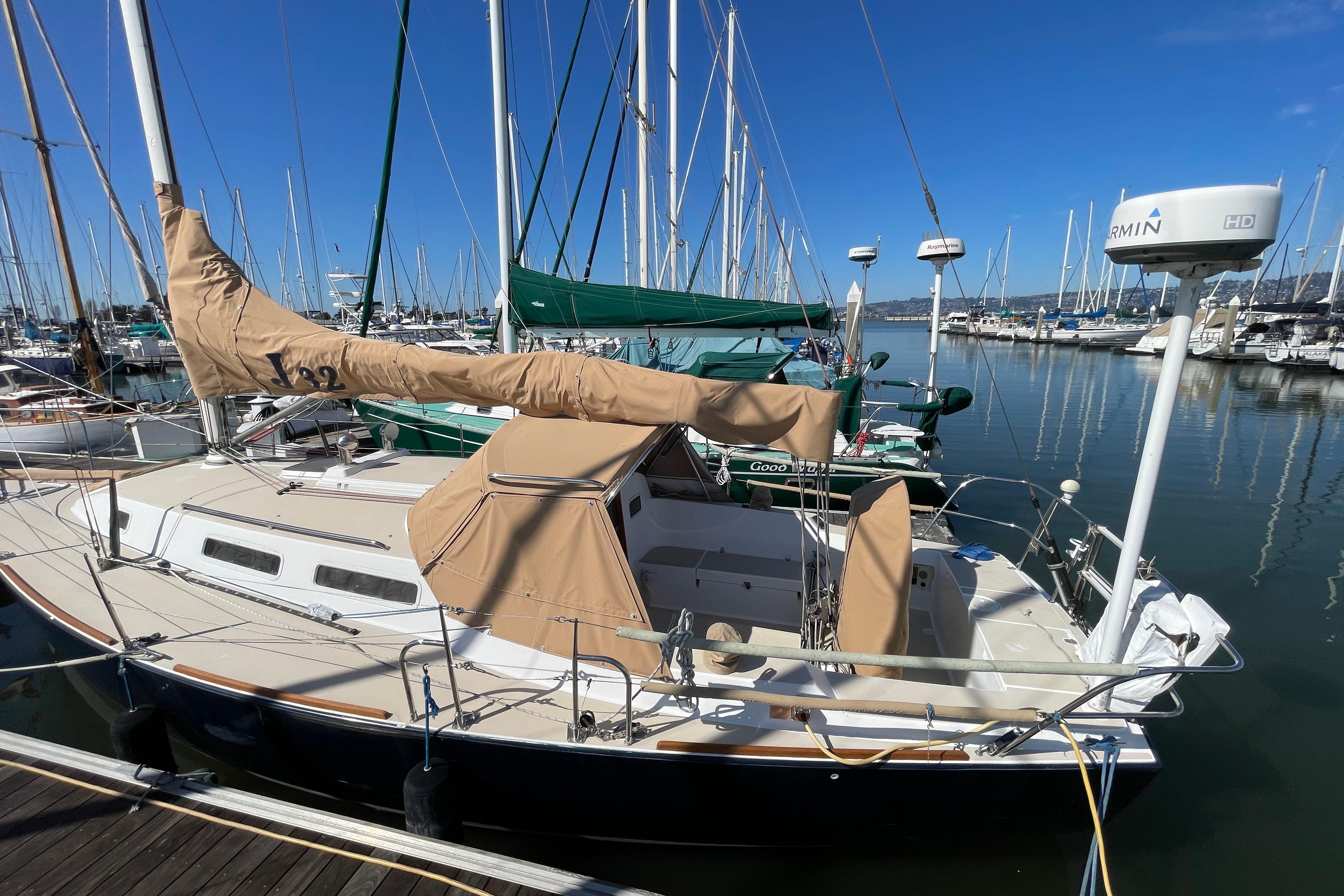 2001 J Boats J/32 sailboat docked at a marina under clear blue skies.