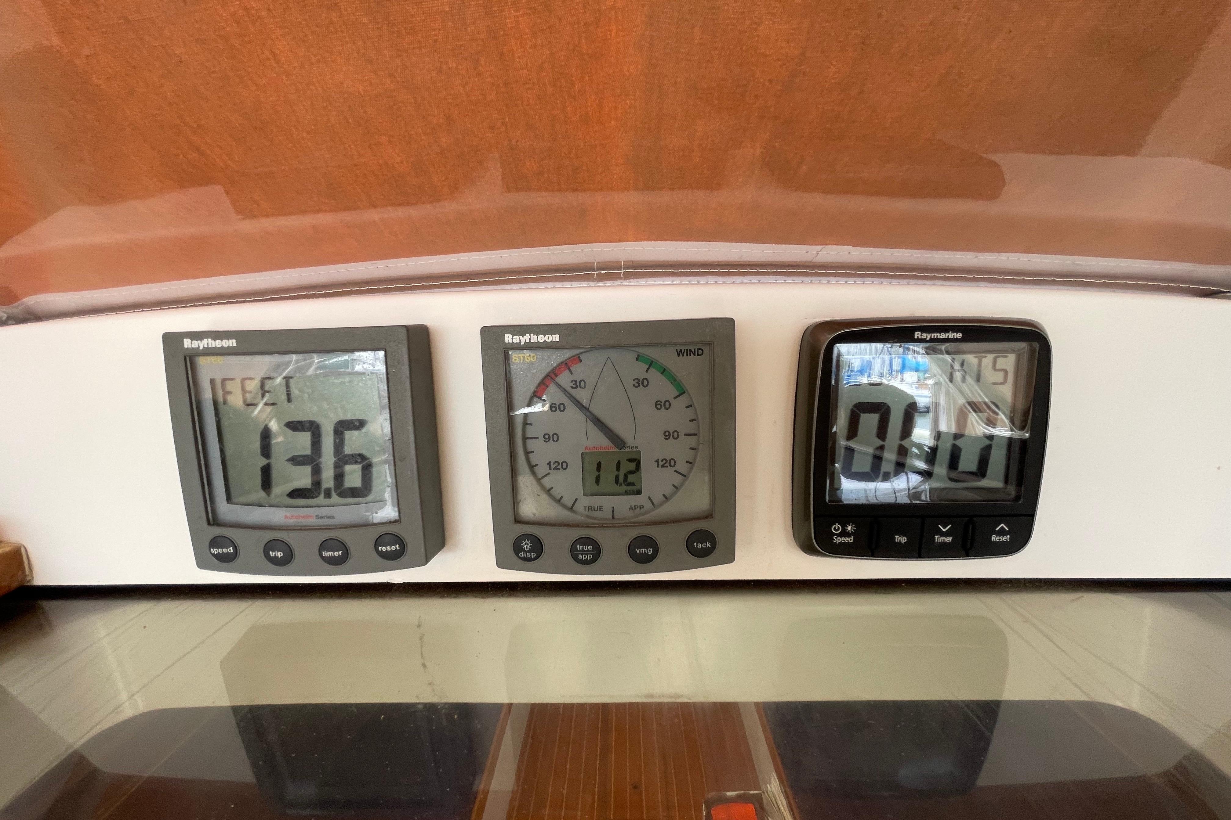 Raytheon and Raymarine instruments on a 2001 J Boats J/32 sailboat dashboard.