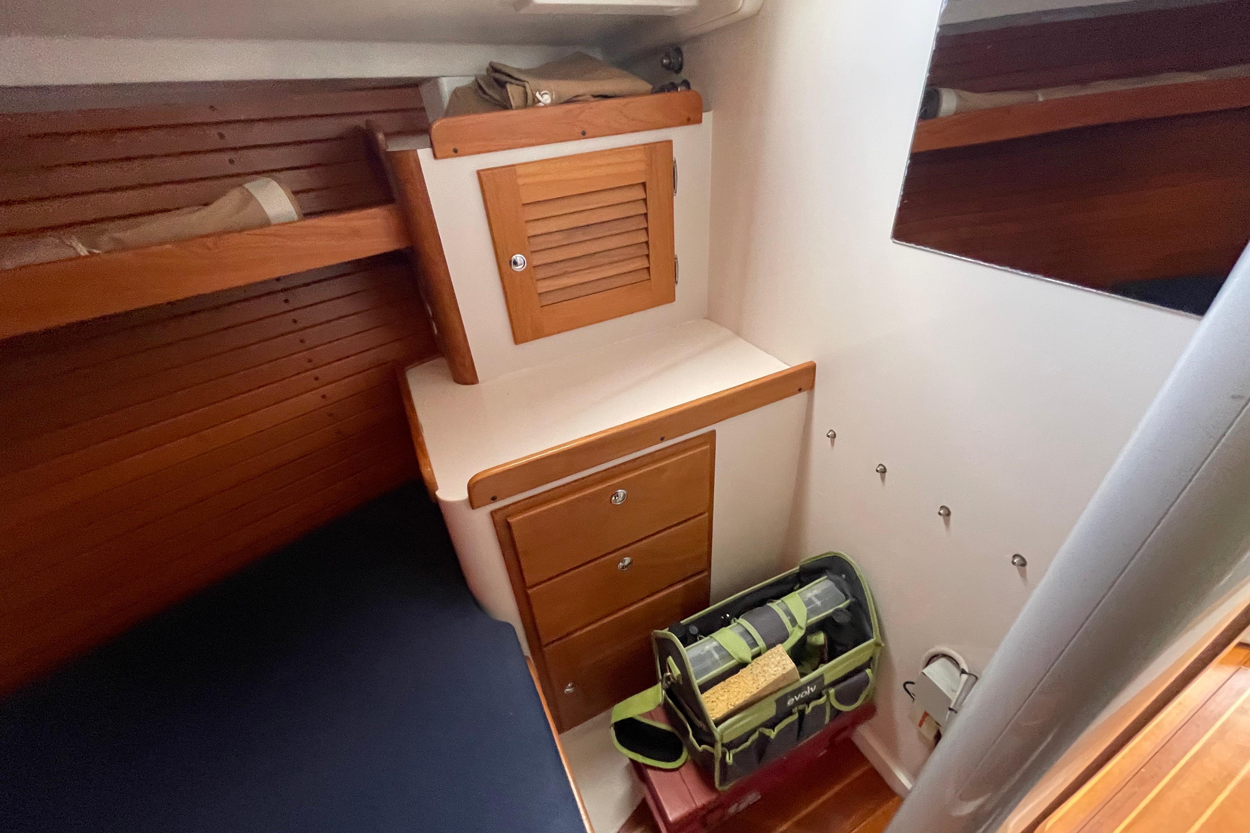 Interior cabin of 2001 J Boats J/32 with wooden cabinetry and storage.