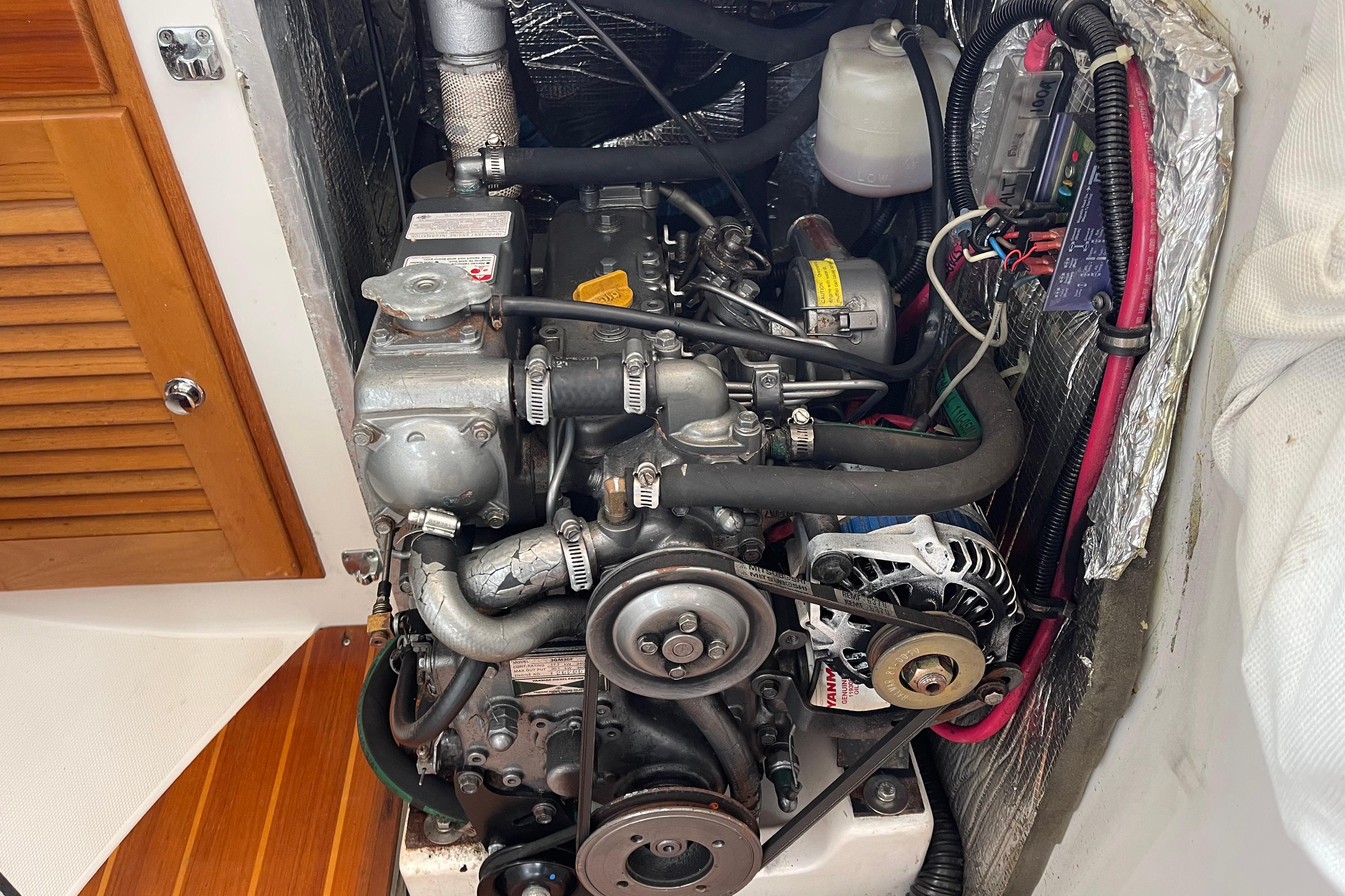 Engine compartment of a 2001 J Boats J/32 sailboat, showcasing detailed mechanical components.