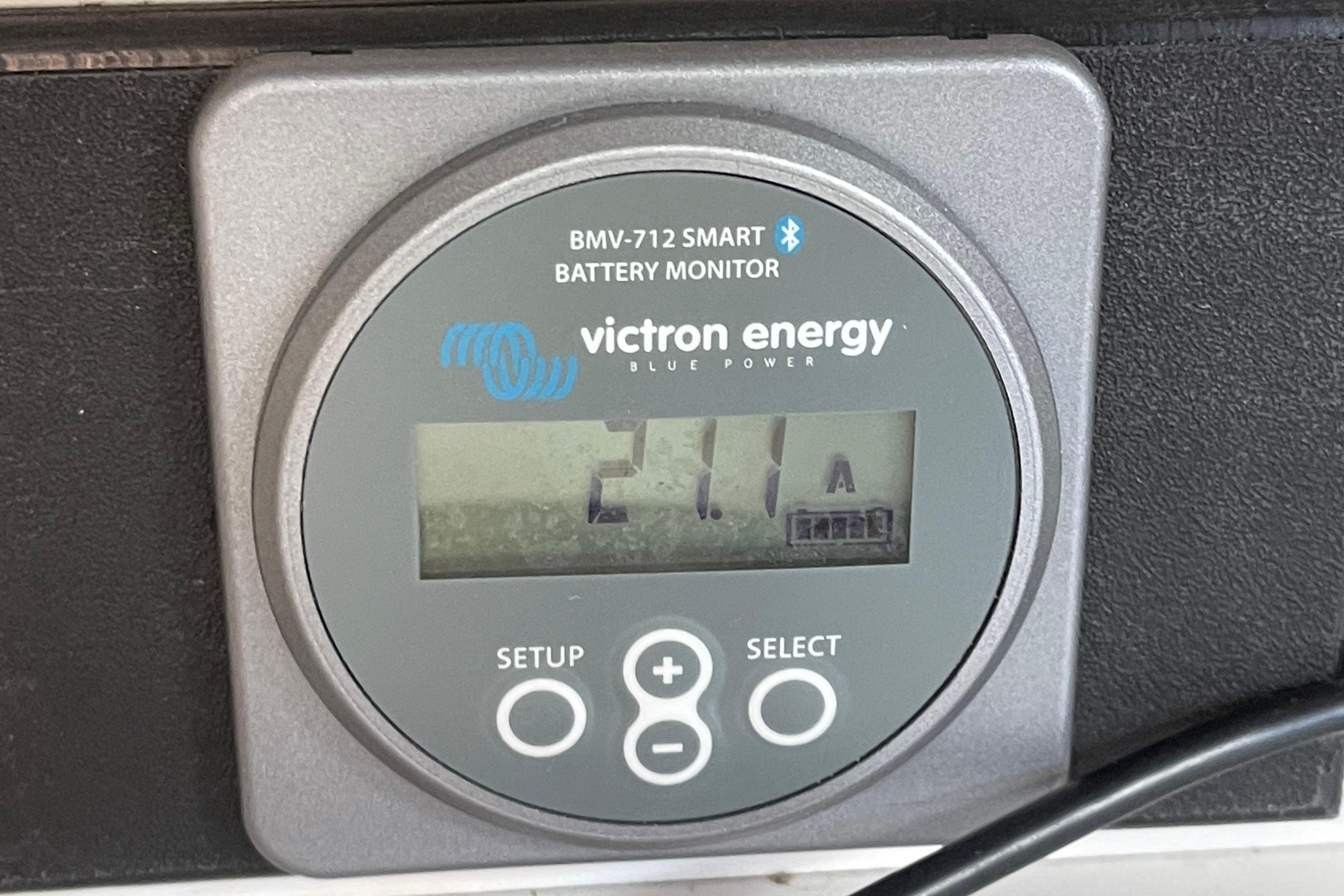 Victron Energy BMV-712 battery monitor displaying 21.1A on a 2001 J Boats J/32.