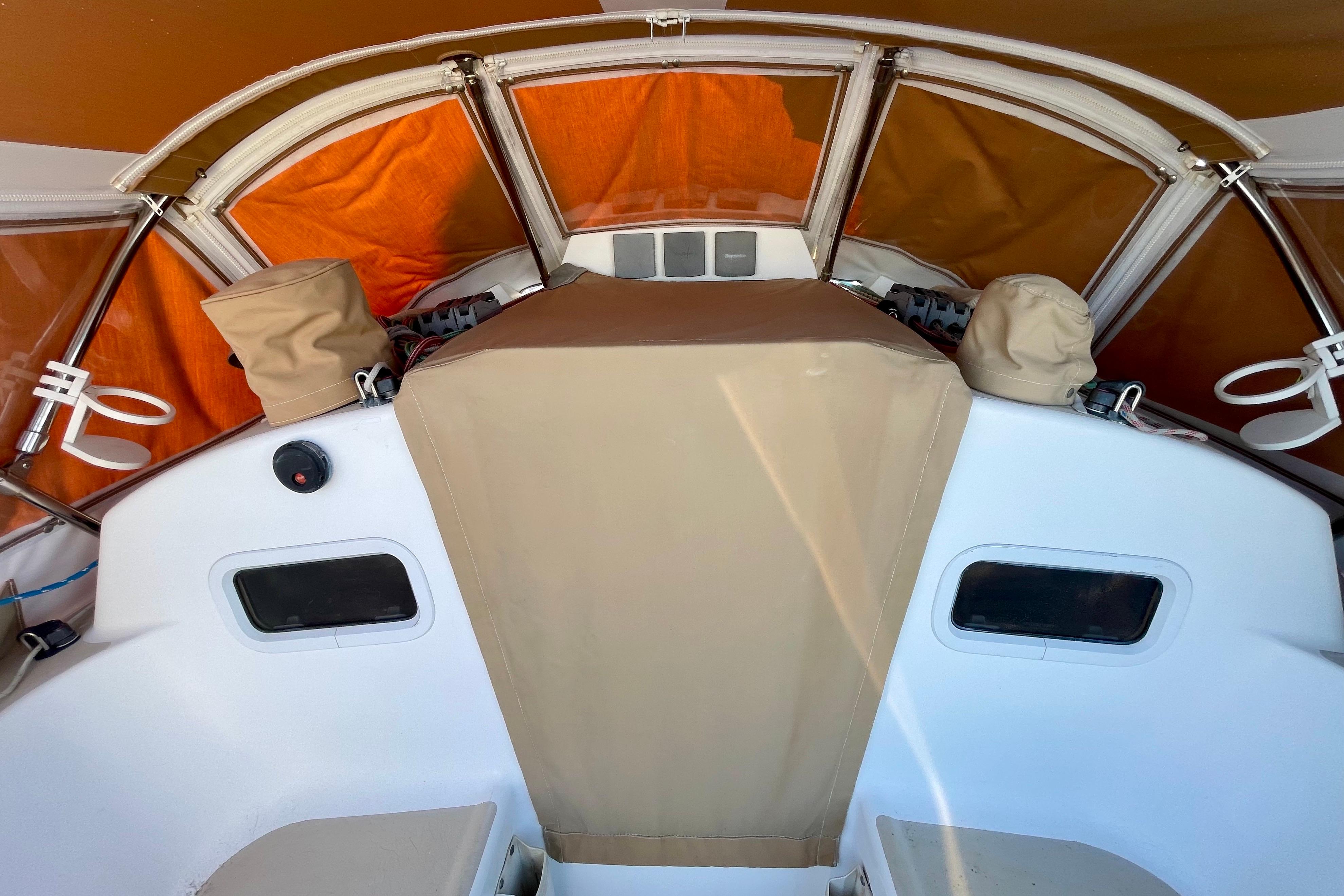 2001 J Boats J/32 cockpit with tan covers and orange canopy.