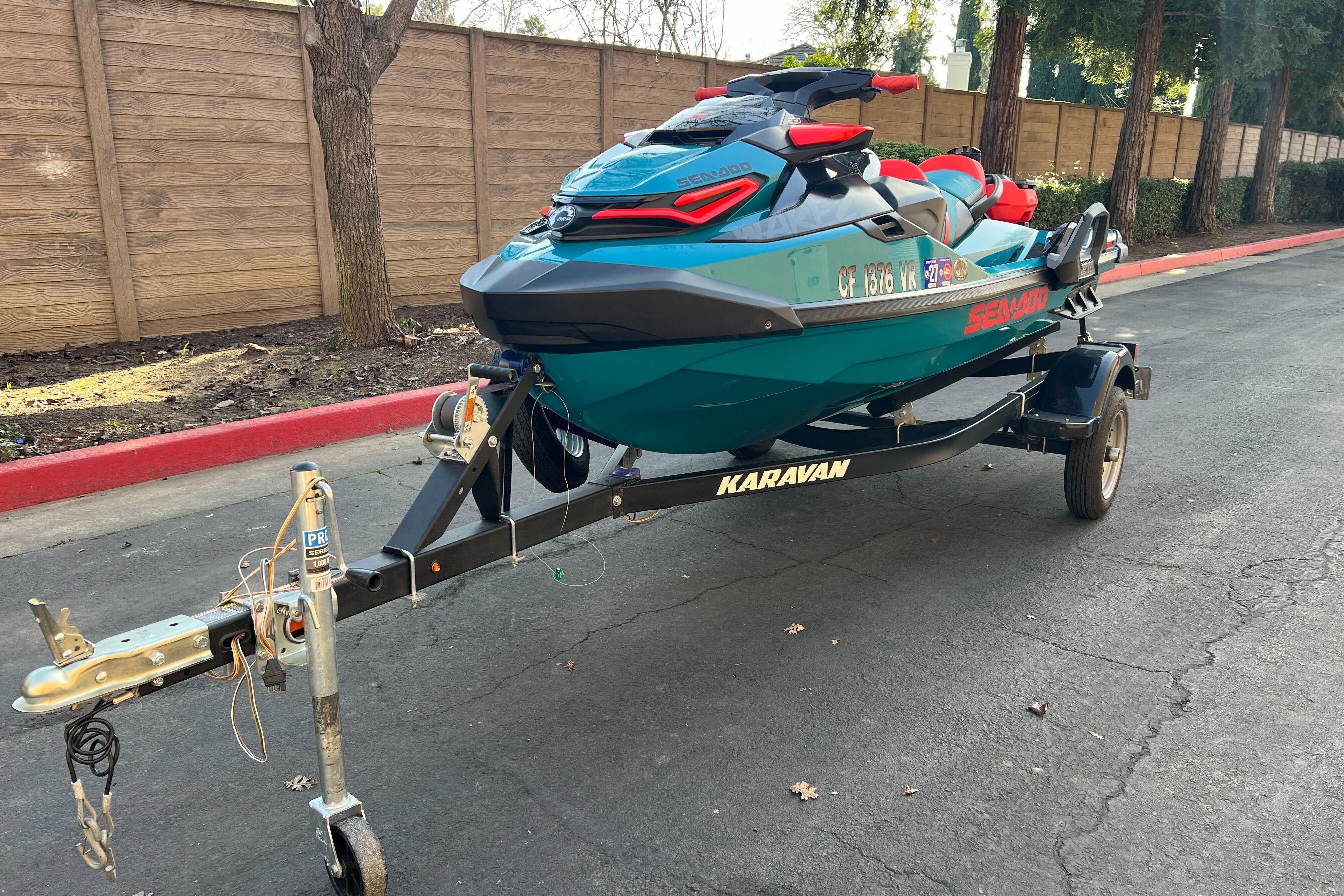 2018 Sea-Doo Wake Pro 230 on a Karavan trailer, parked on a paved road.