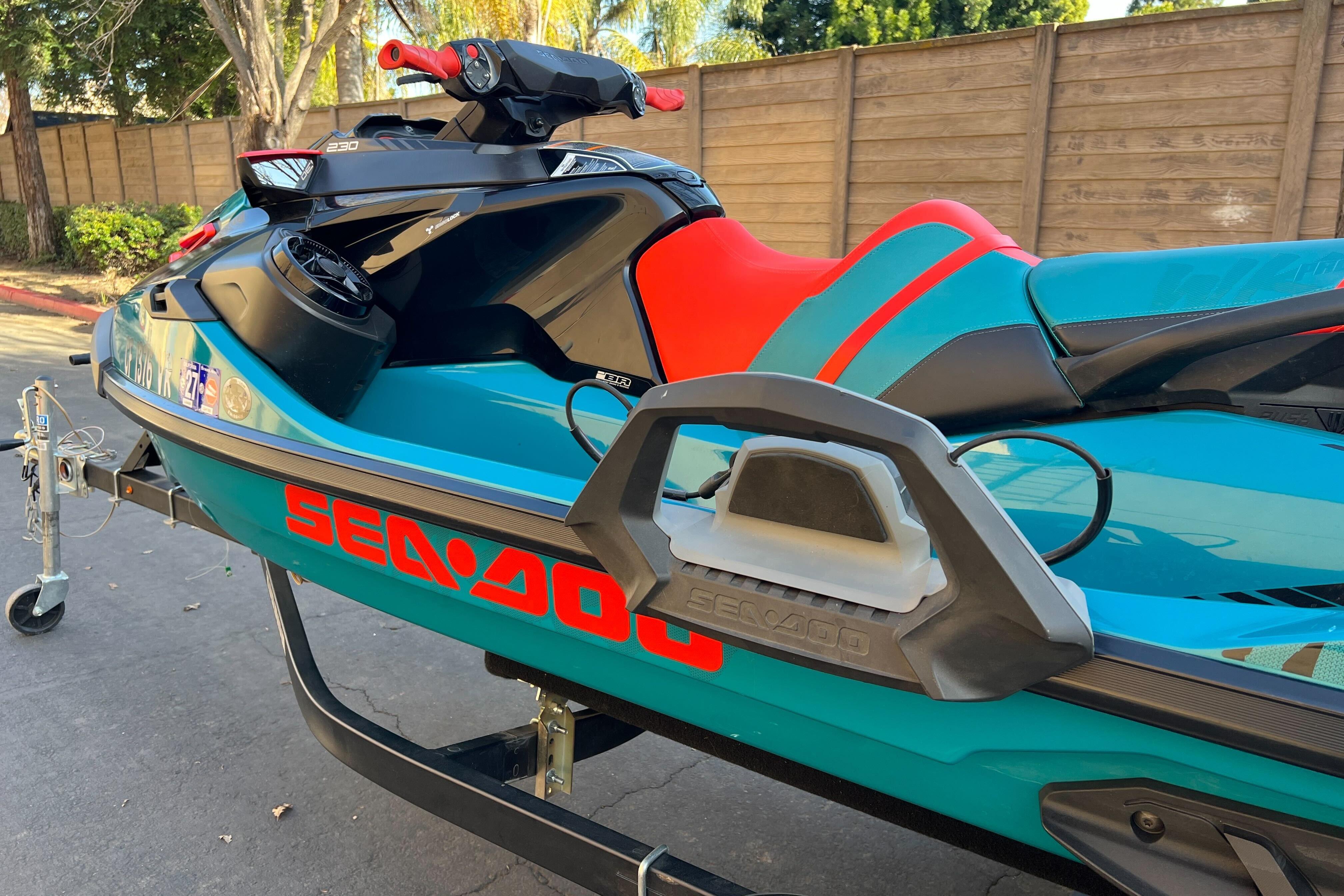 2018 Sea-Doo Wake Pro 230 jet ski on trailer, vibrant blue and red design.