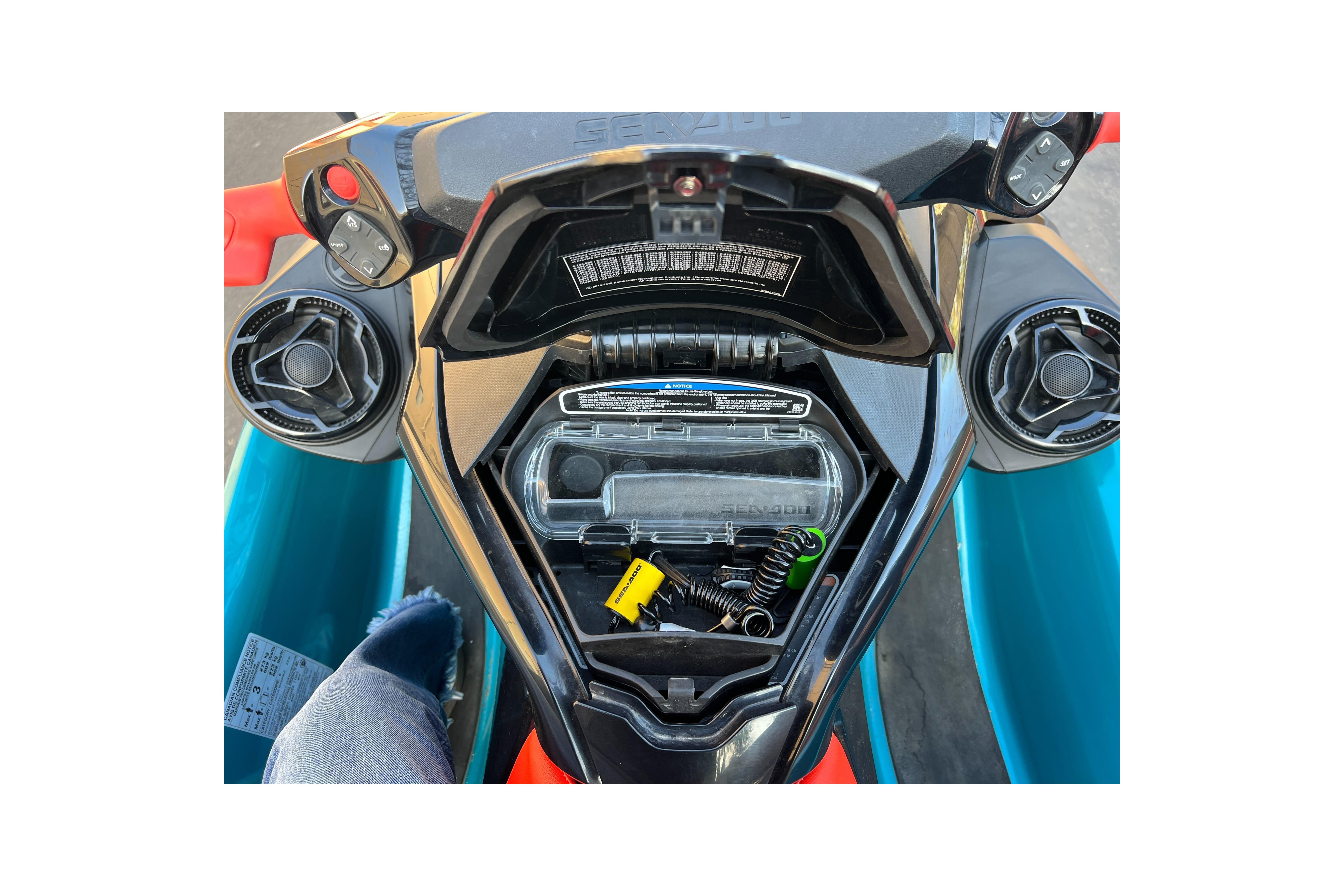 2018 Sea-Doo Wake Pro 230 dashboard with storage compartment open, showing controls and accessories.