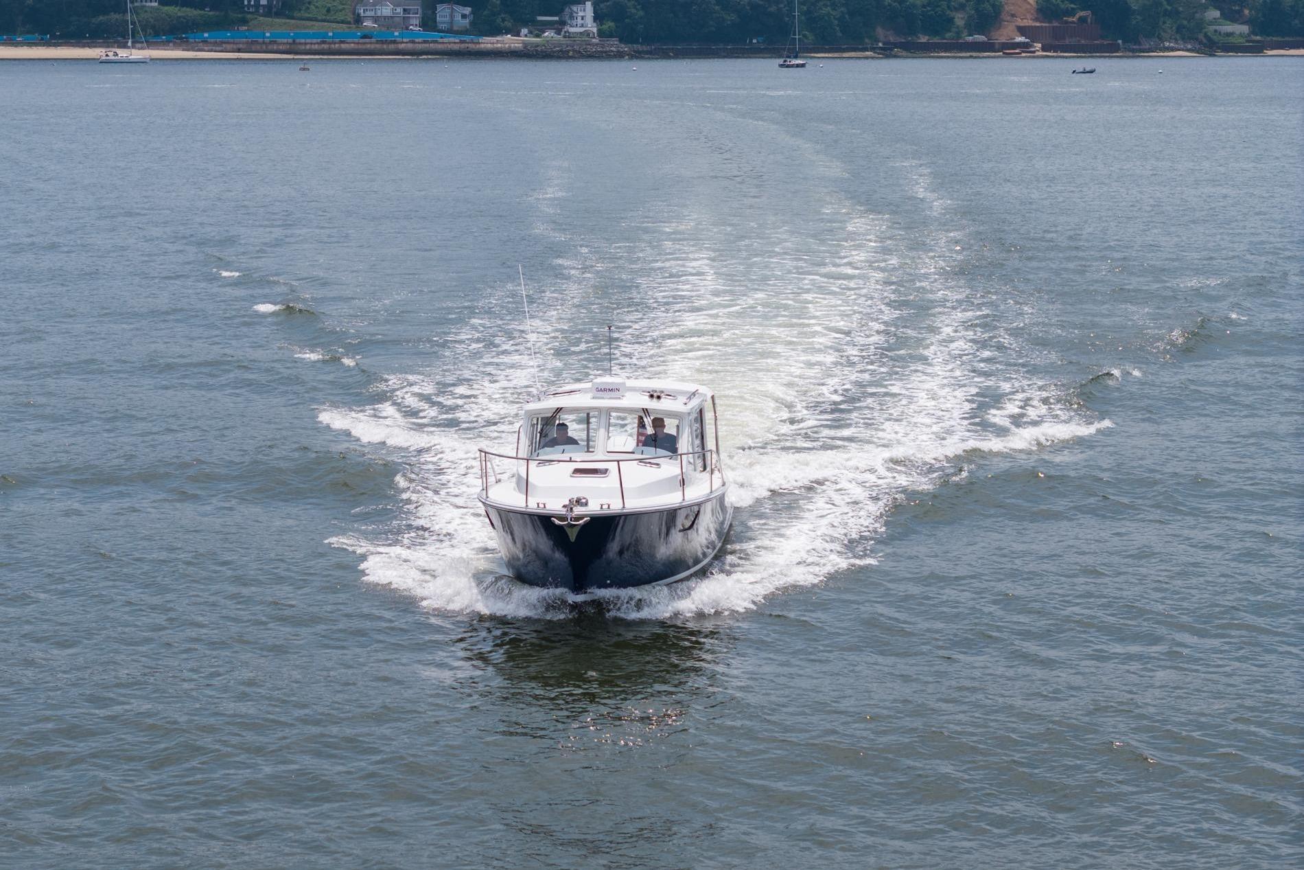 2025 MJM 35 boat cruising on open water, leaving a wake behind.