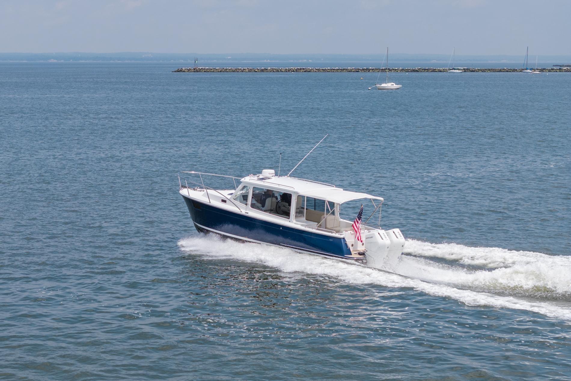 2025 MJM 35 boat cruising on open water with American flag.