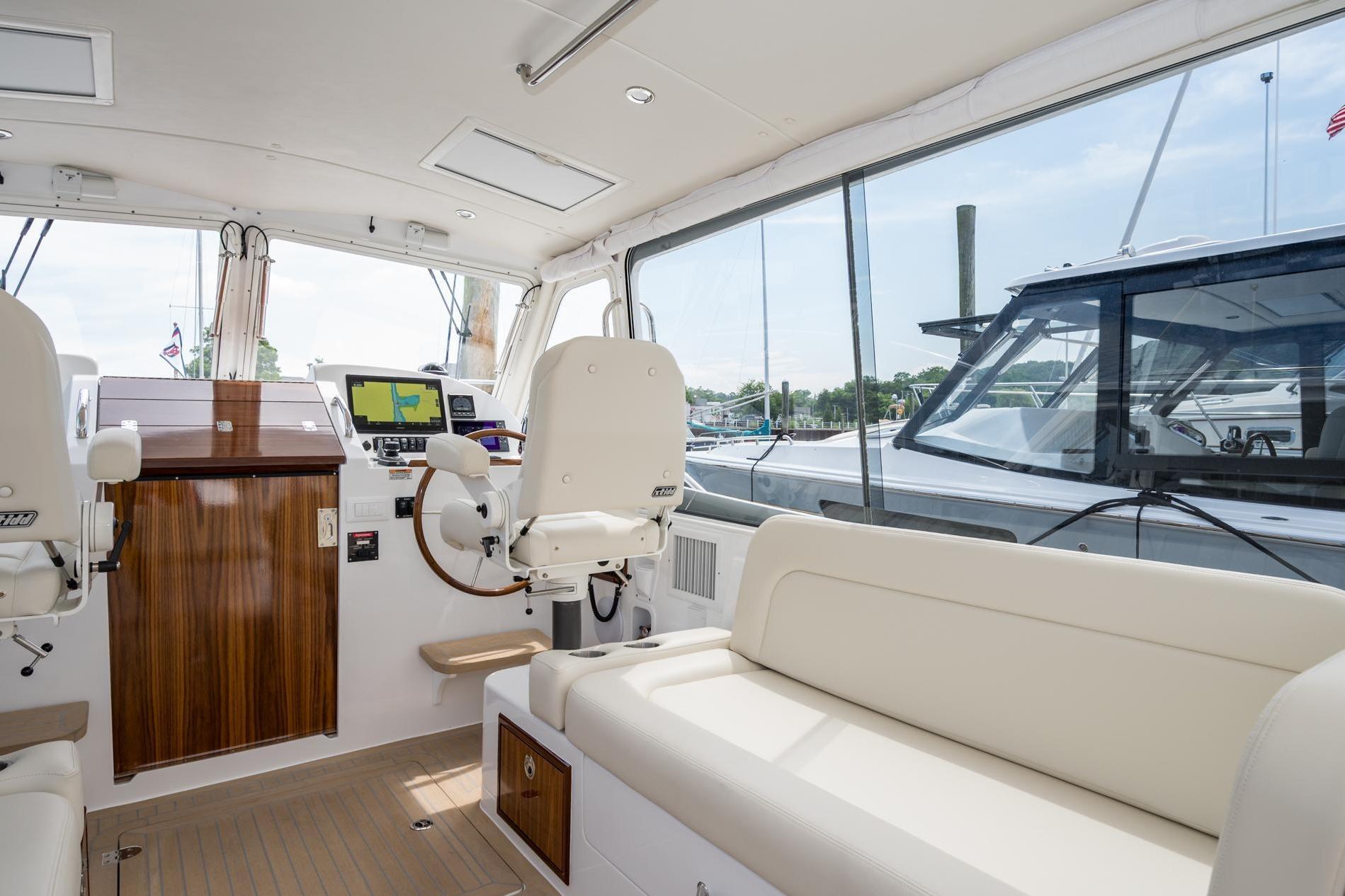Interior of 2025 MJM 35 yacht with helm, seating, and navigation equipment.