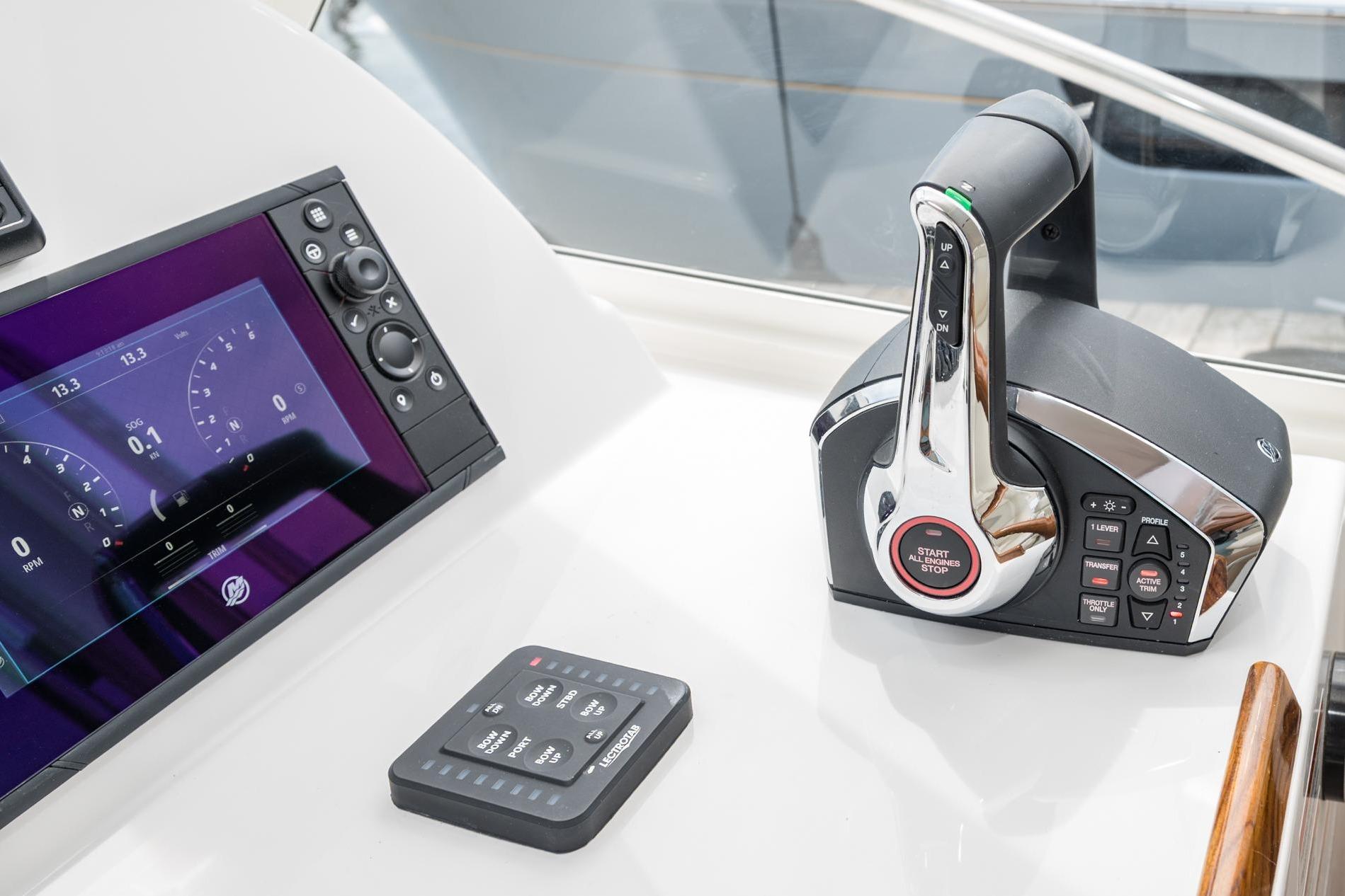 Control panel of 2025 MJM 35 boat with throttle and display screen.