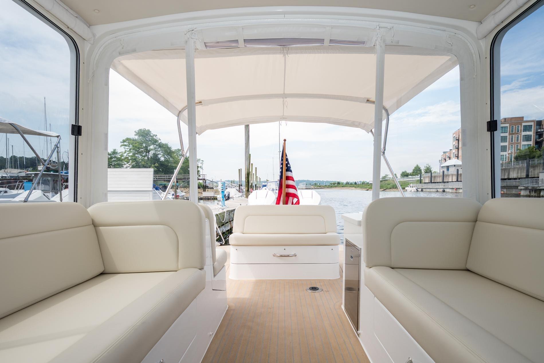 2025 MJM 35 boat interior with beige seating and American flag.