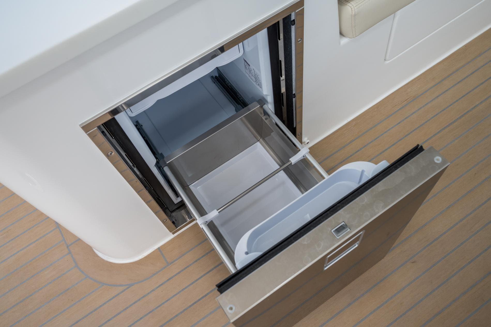 Open drawer refrigerator on 2025 MJM 35 boat, showcasing modern design and functionality.