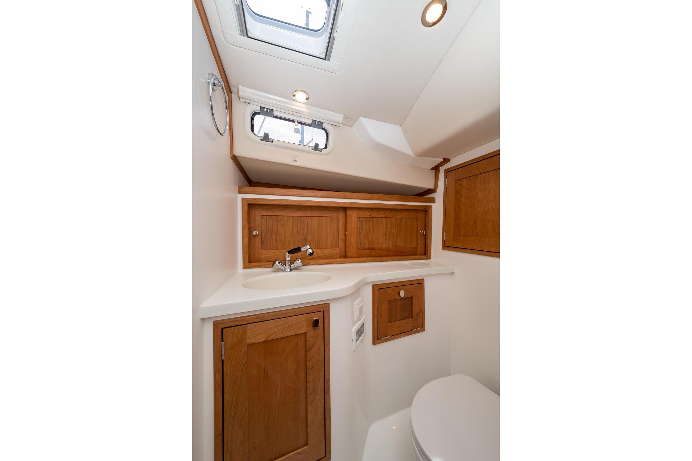 2025 MJM 35 yacht bathroom with wooden cabinets and modern fixtures.