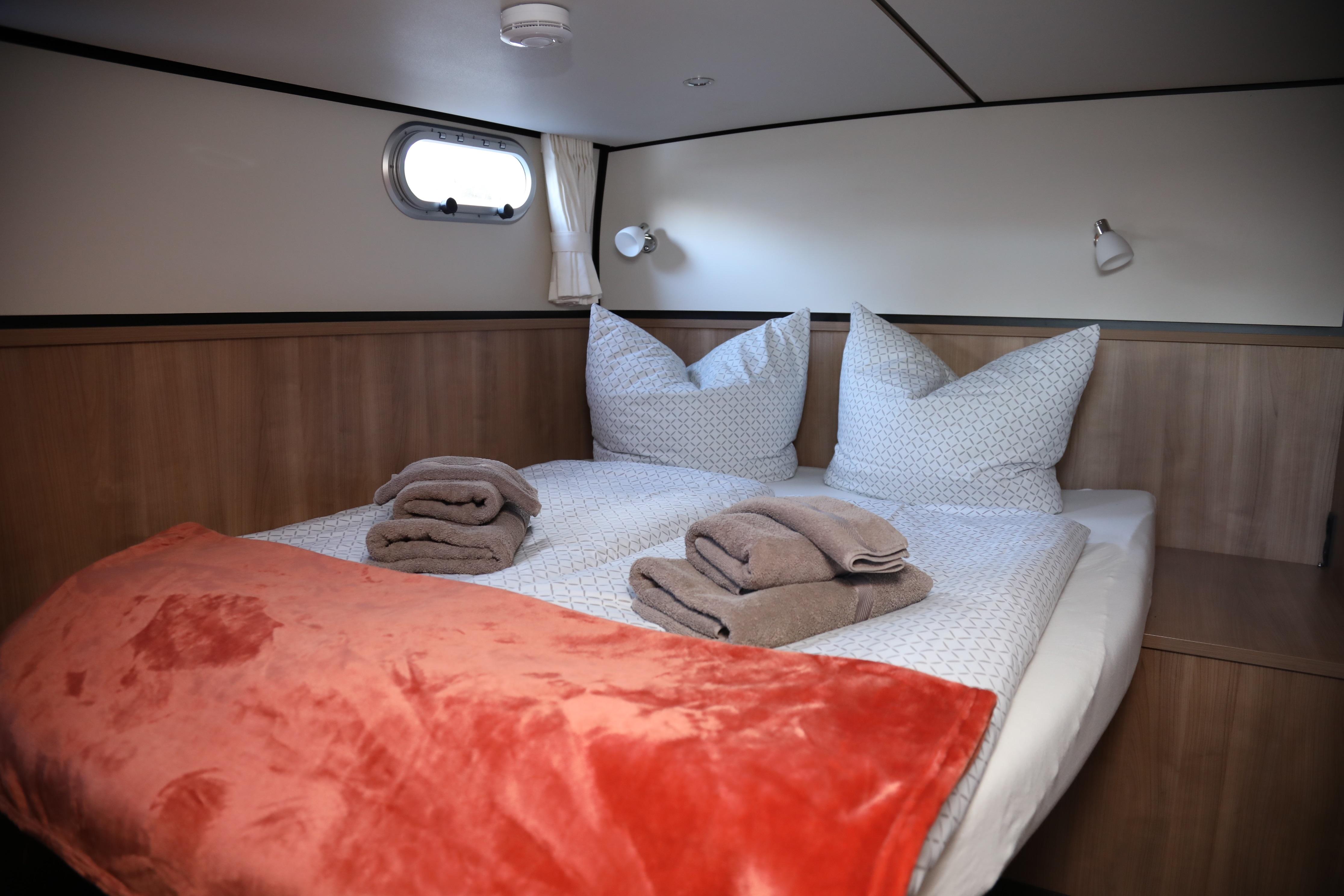 Cozy bedroom in 2022 Linssen Grand Sturdy 35.0 AC INTERO yacht with plush bedding.