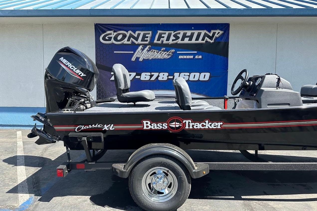2026 Tracker Bass Tracker Classic XL boat with Mercury engine, parked outside dealership.