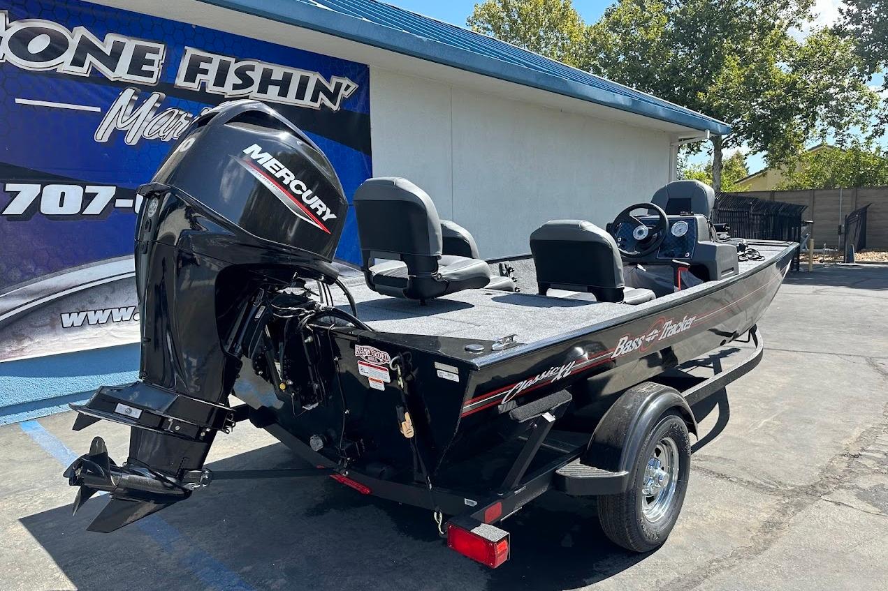 2026 Tracker Bass Tracker Classic XL boat with Mercury engine, parked outdoors.